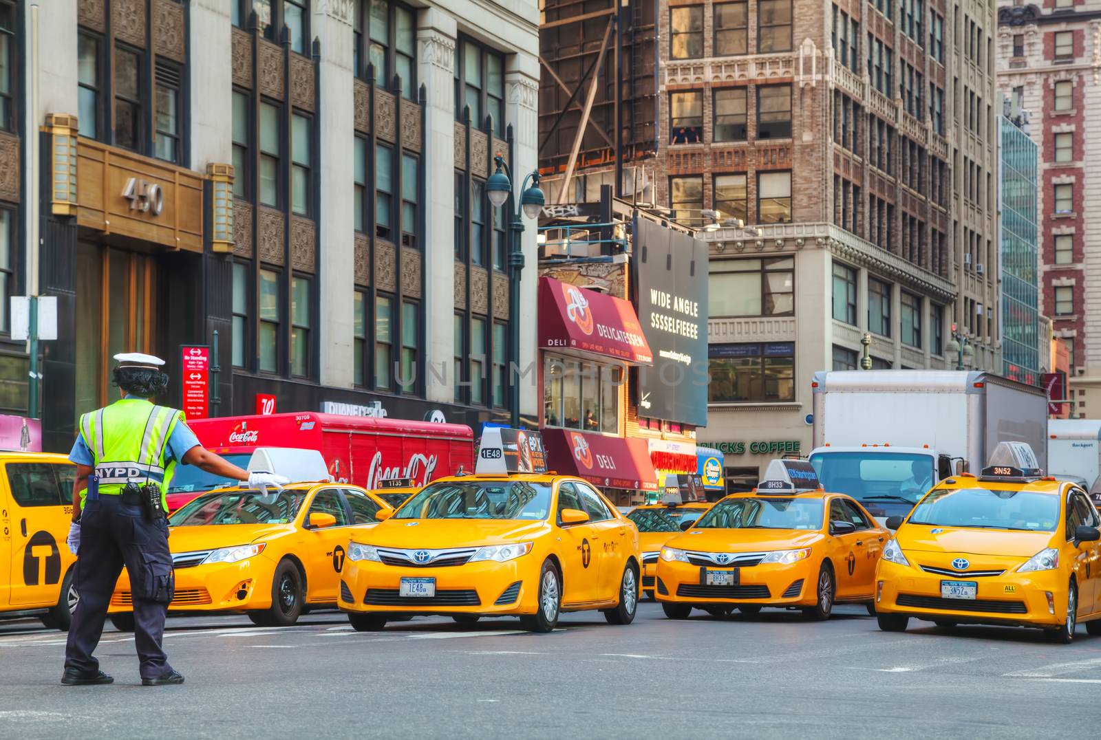 NEW YORK CITY - SEPTEMBER 4: Yellow taxis at the street on September 4, 2015 in New York. Yellow cars serve as taxis in NYC and are easy to spot among other vehicles because of their color.