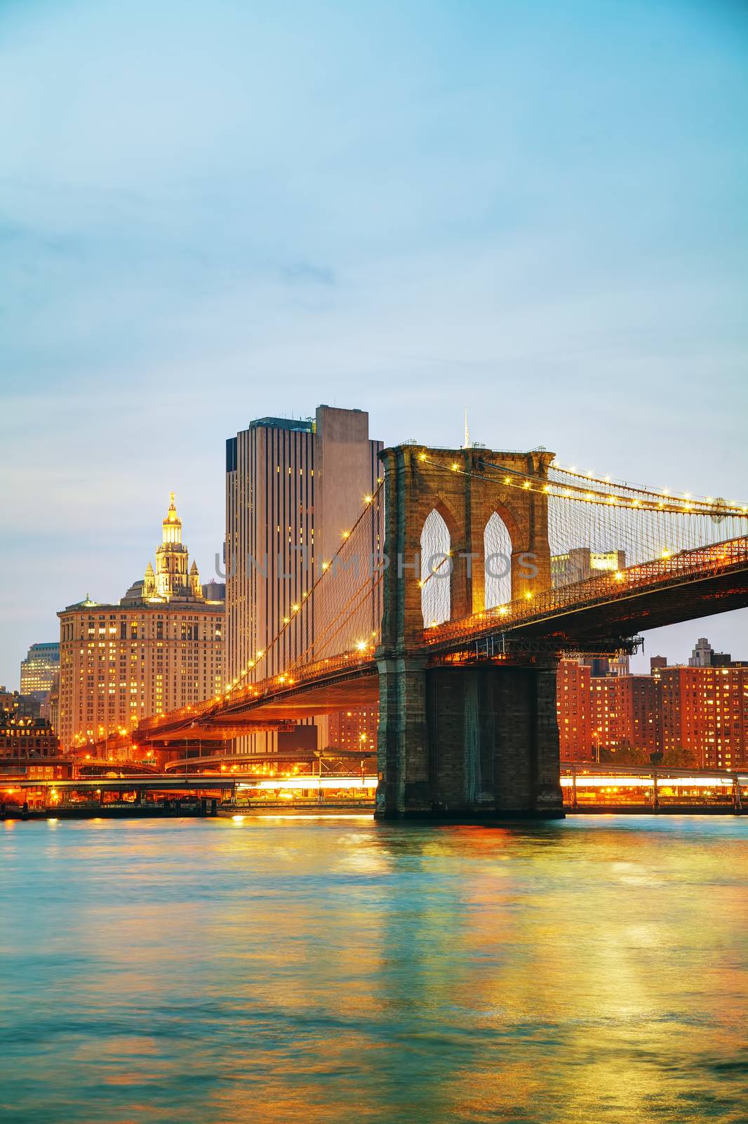 Lower Manhattan cityscape with the Brooklyn bridge at sunset