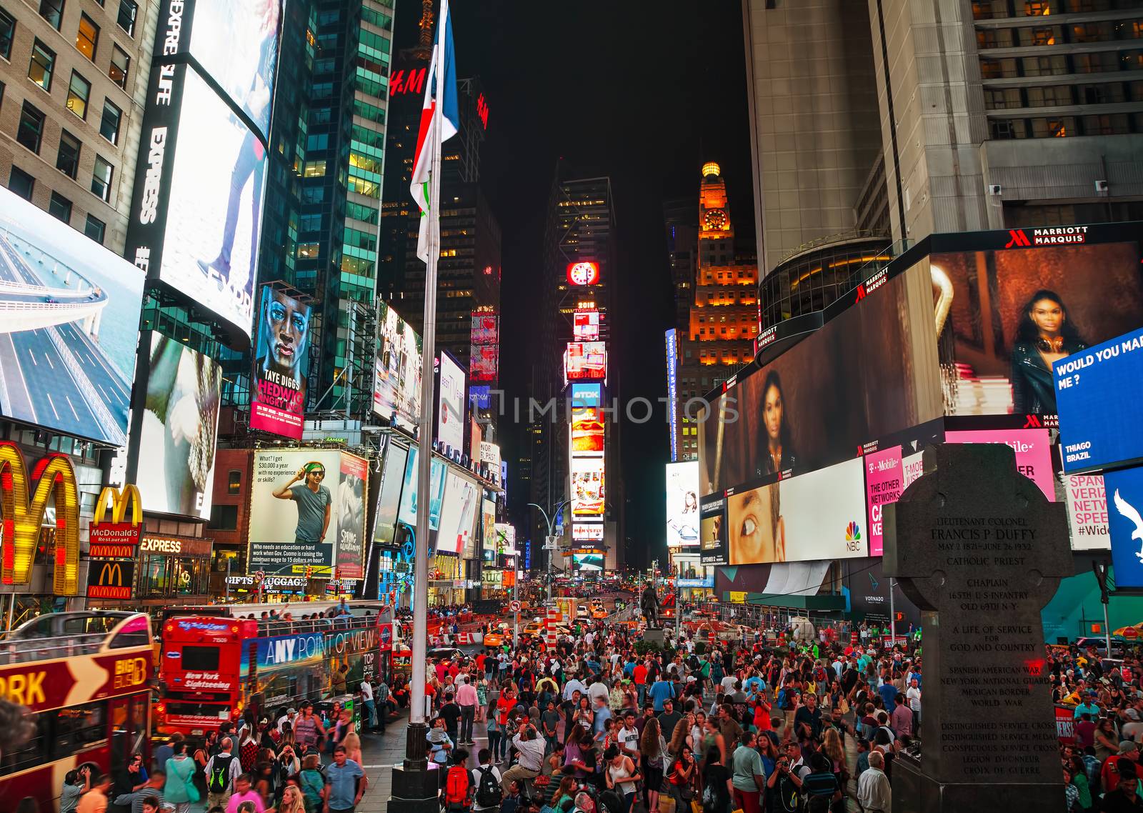 NEW YORK CITY - SEPTEMBER 05: Times square with people in the night on September 5, 2015 in New York City. It's major commercial intersection and neighborhood in Midtown Manhattan at the junction of Broadway and 7th Avenue.