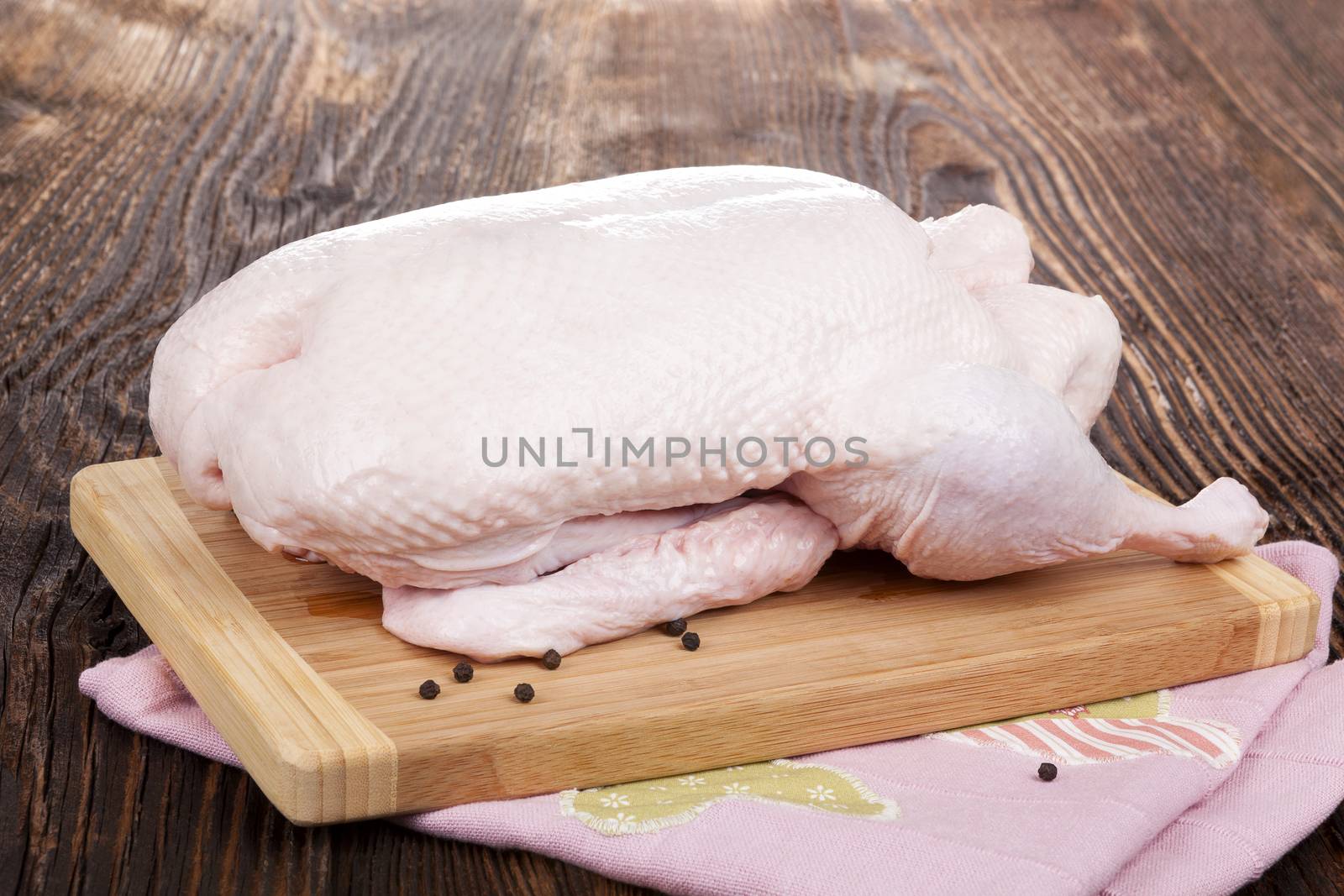 Fresh raw duck isolated on wooden rustic table. Culinary cooking.