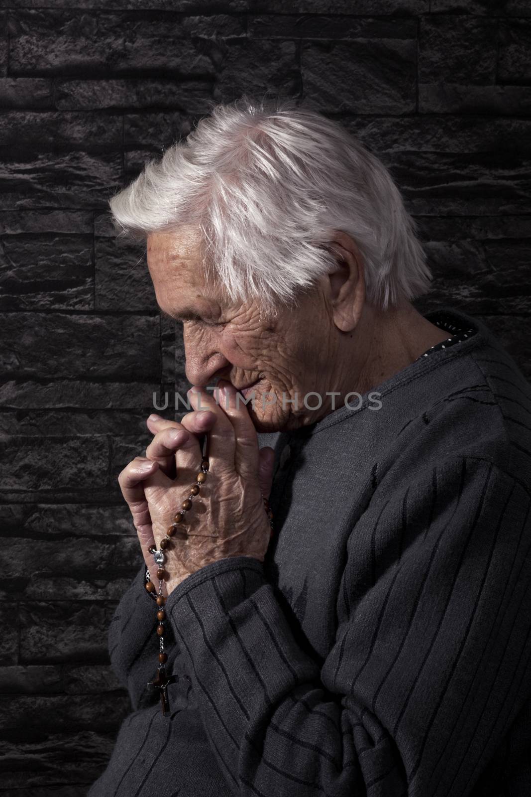 Grandmother praying. by eskymaks