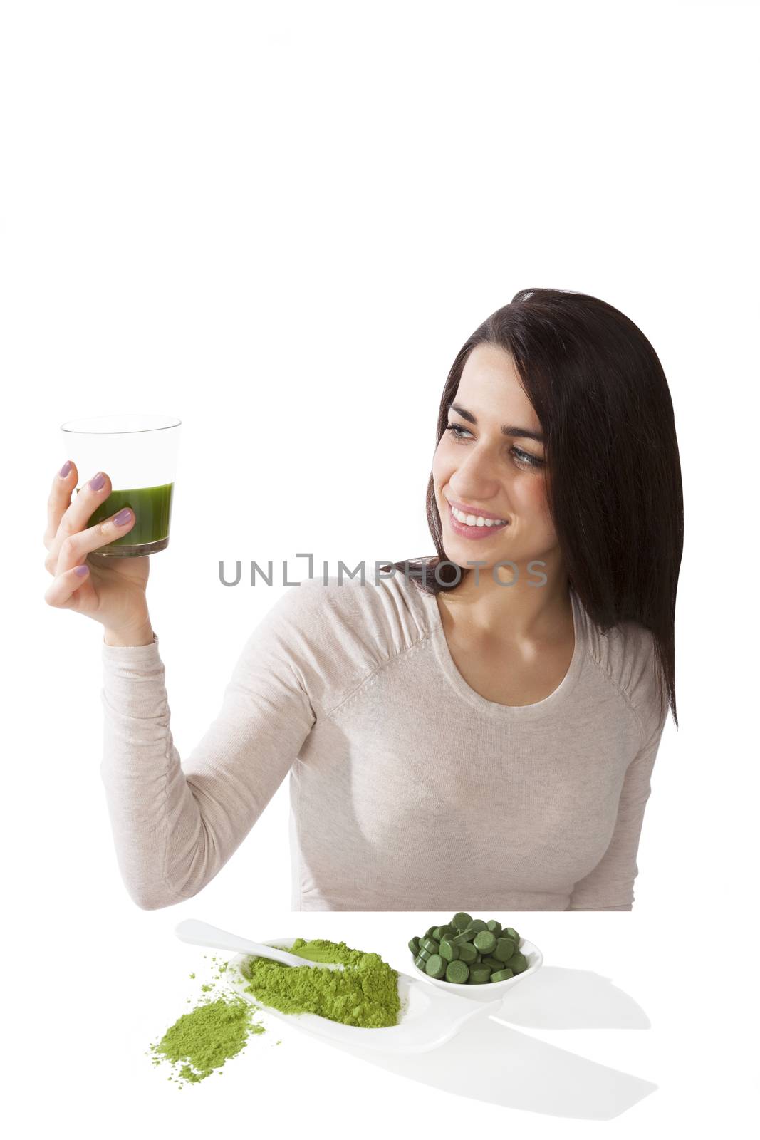 Detox. Beautiful girl with green ground powder and green pills on spoon isolated on white. Spirulina, chlorella and wheatgrass. Healthy lifestyle, detox.