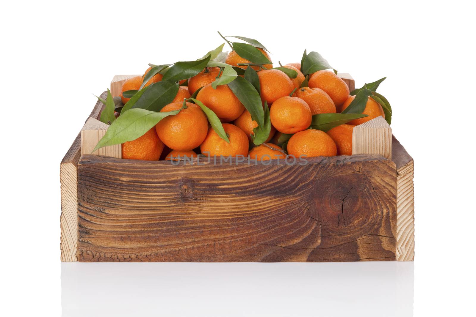 Fresh ripe mandarines in wooden crate. by eskymaks