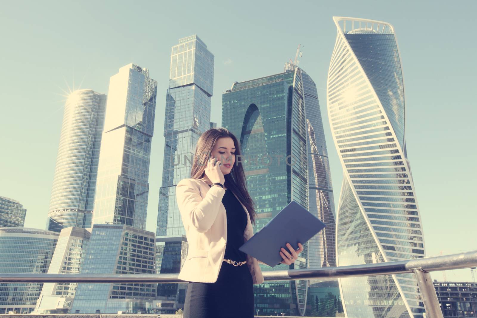 Businesswoman at skyscraper background by ALotOfPeople