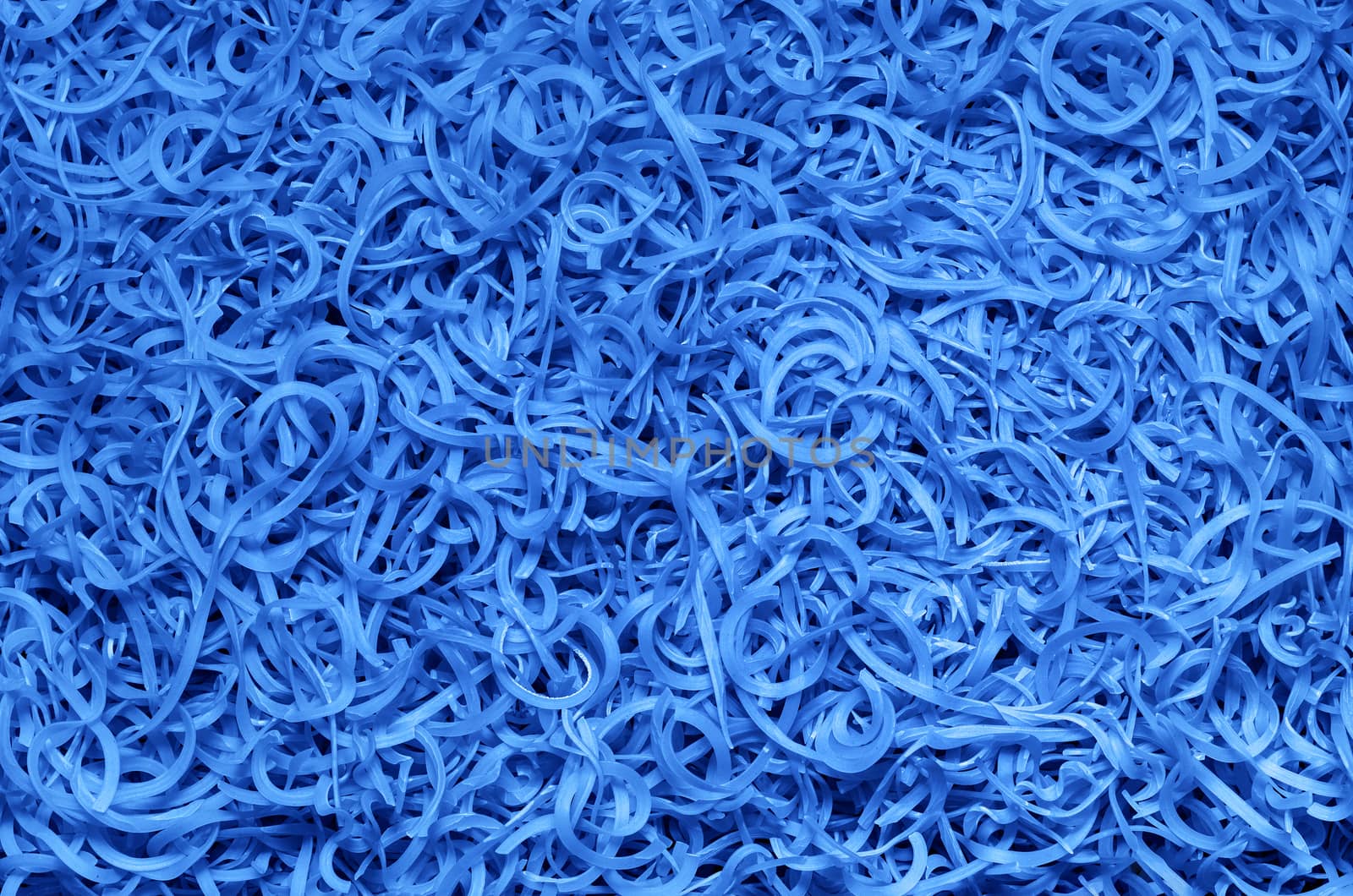 Tinted textured background from the scattered macaroni, blue