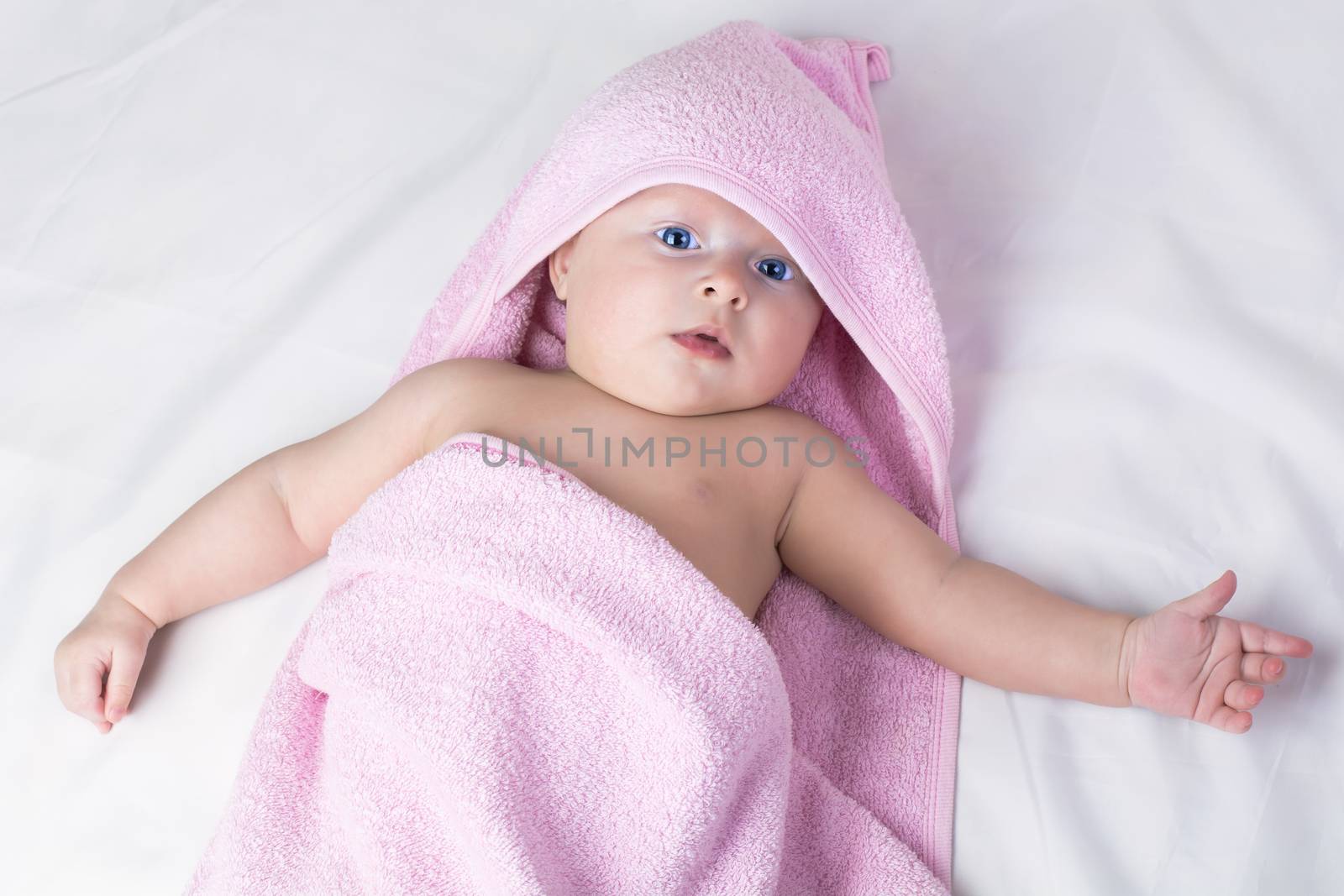 Sweet small baby blue eyes covered with arose  towel