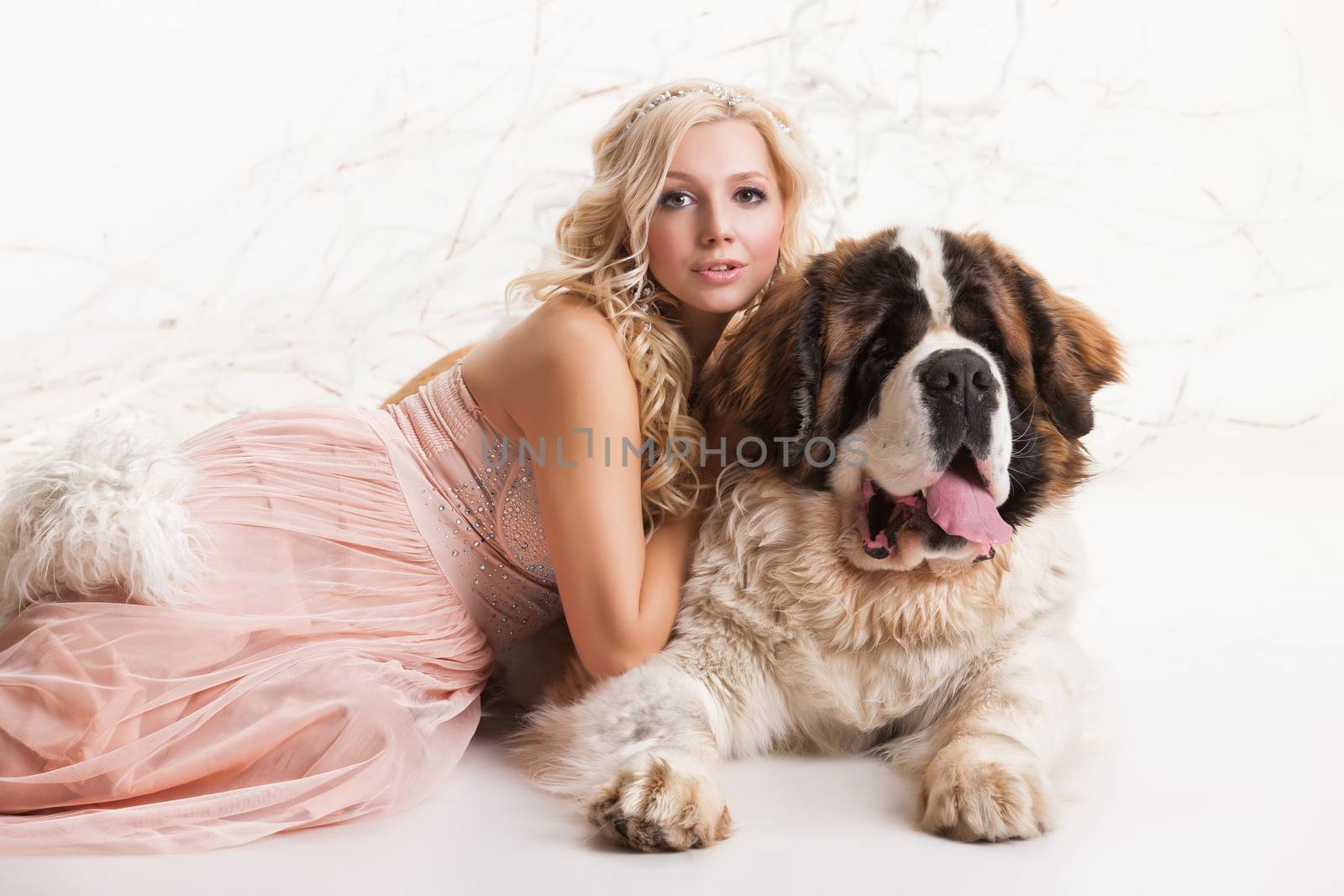 Young woman and big st.bernard in the studio