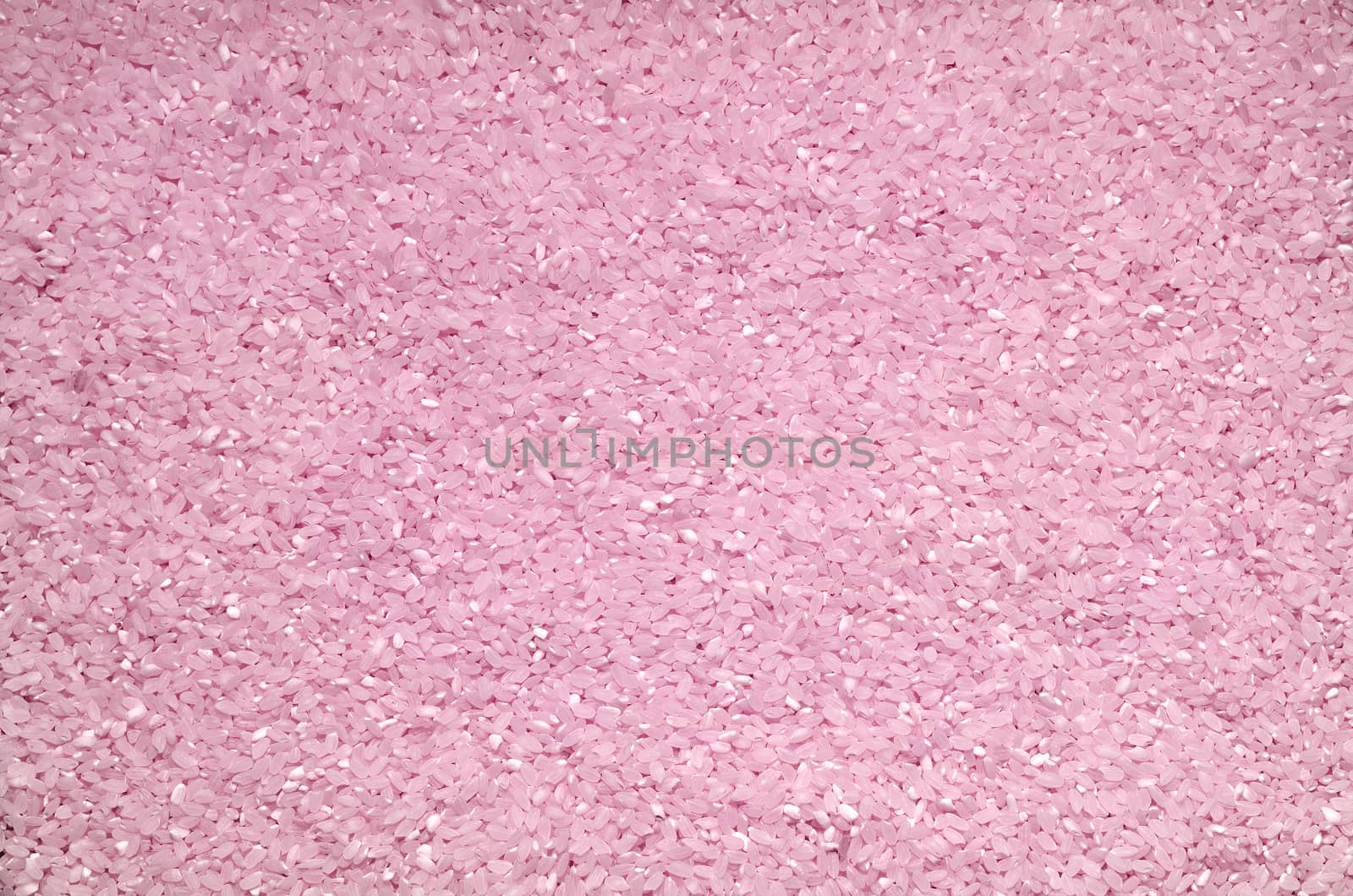 Textured background of rice grains scattered on the surface