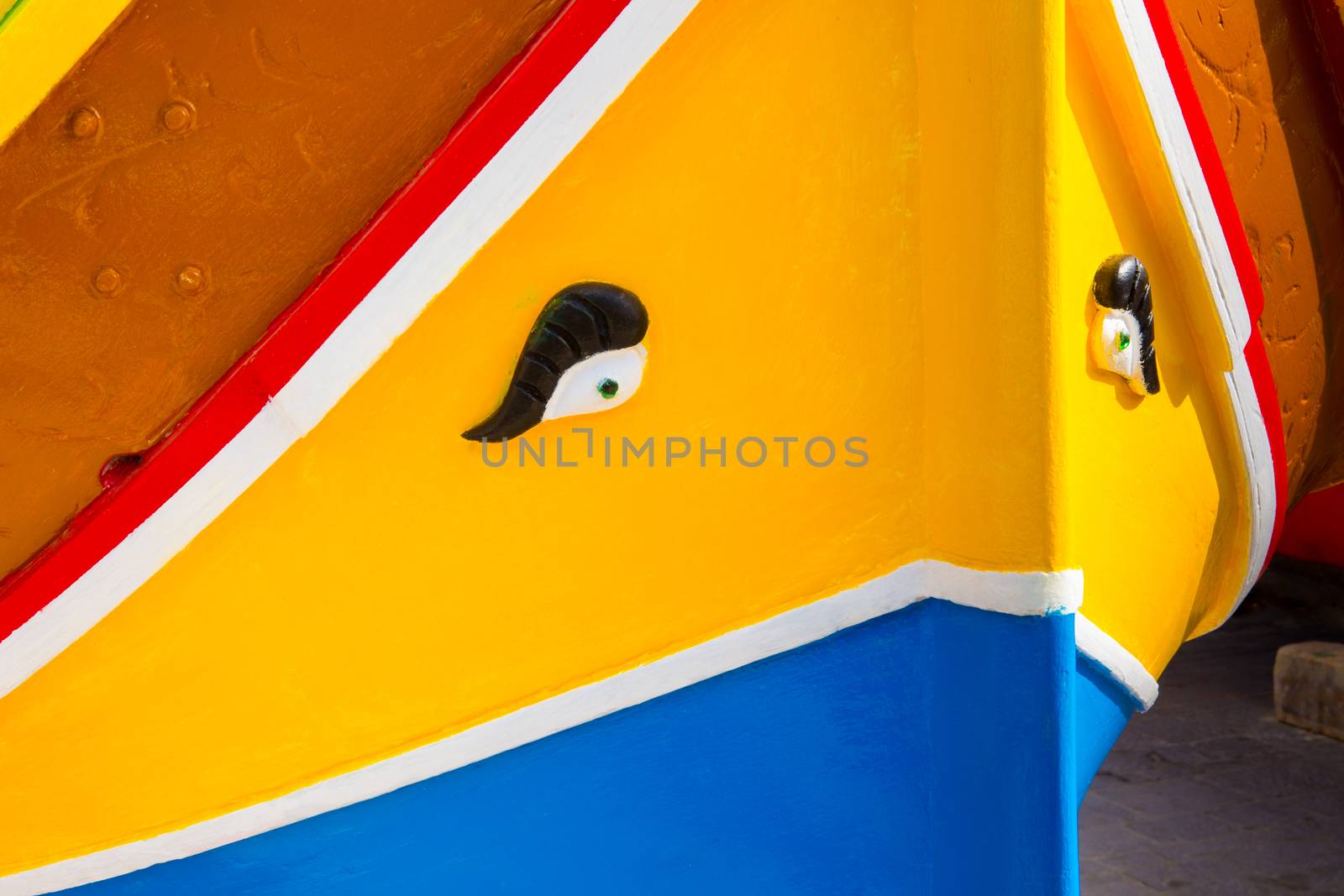 Abstract close up view of the vibrant colours and design usually used on the traditional Maltese fishing boat, the "Dghajsa" or "Luzzu".