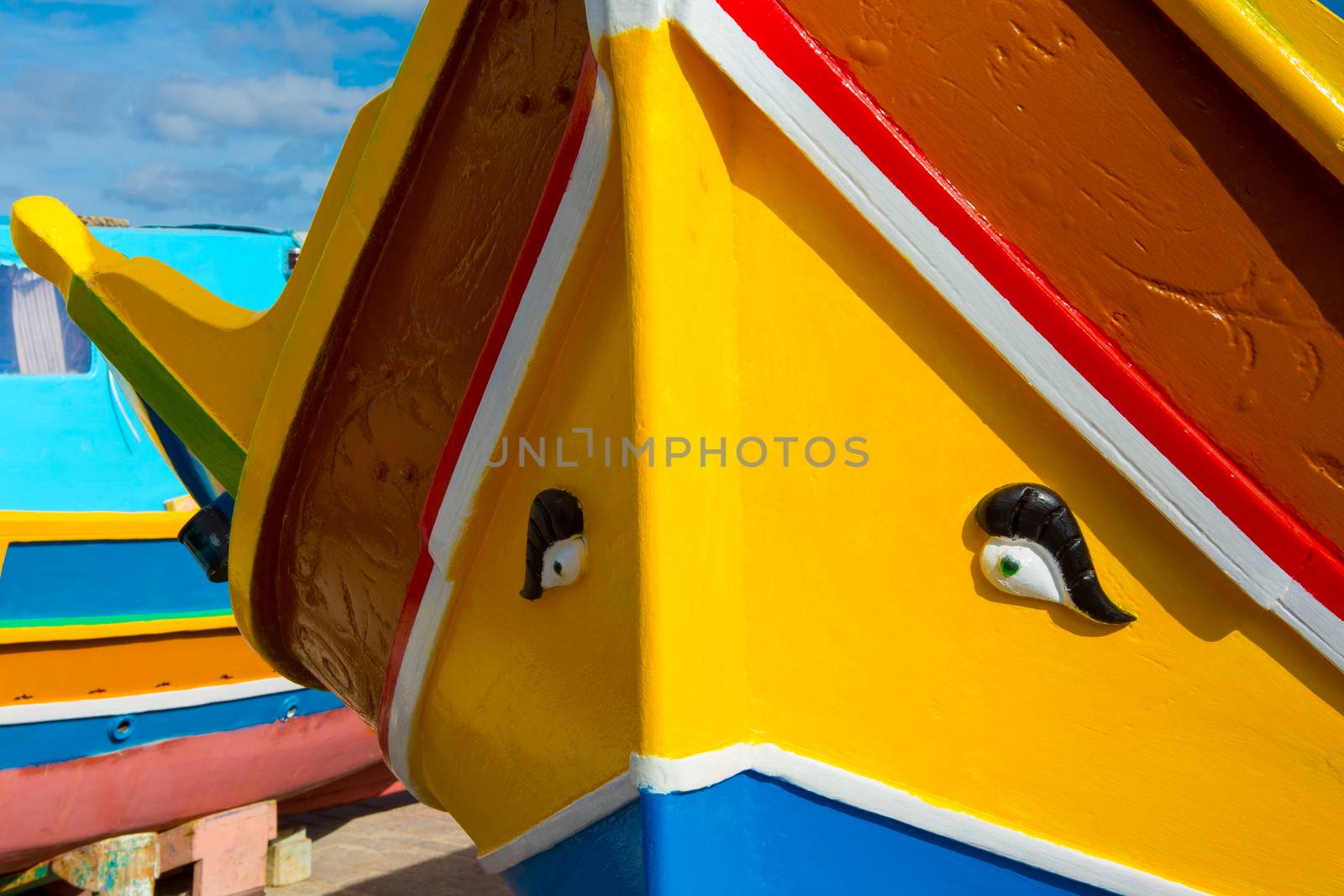 Abstract close up view of the vibrant colours and design usually used on the traditional Maltese fishing boat, the "Dghajsa" or "Luzzu".