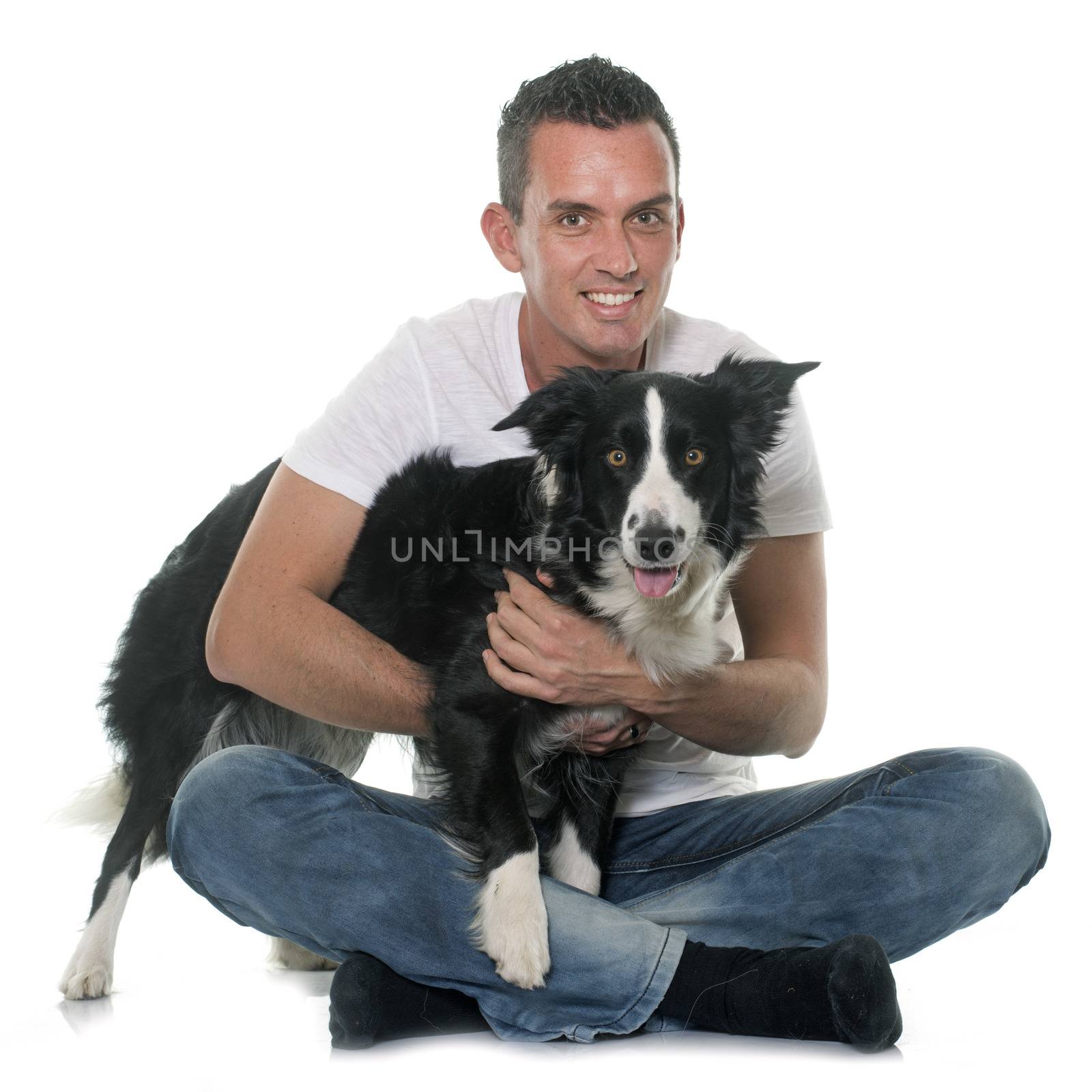 man and border collie in front of white background