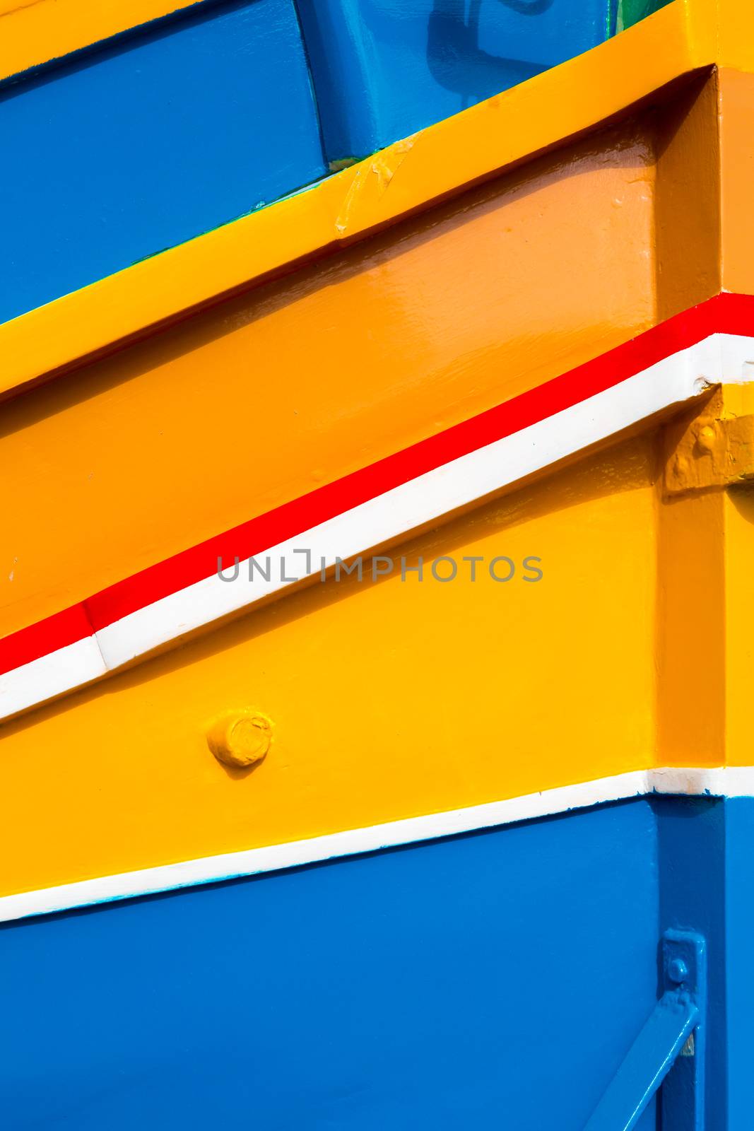 Abstract close up view of the vibrant colours and design usually used on the traditional Maltese fishing boat, the "Dghajsa" or "Luzzu".