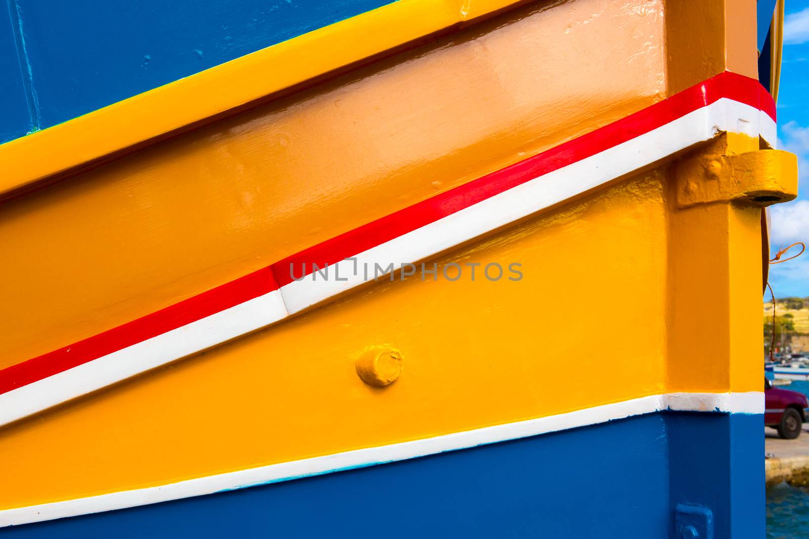 Abstract close up view of the vibrant colours and design usually used on the traditional Maltese fishing boat, the "Dghajsa" or "Luzzu".