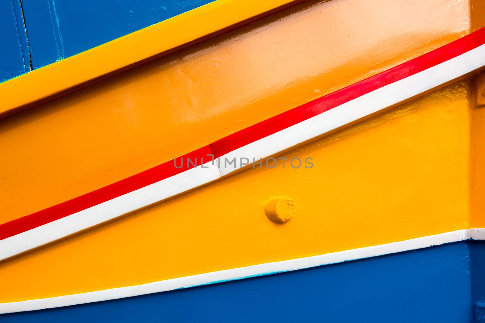 Abstract close up view of the vibrant colours and design usually used on the traditional Maltese fishing boat, the "Dghajsa" or "Luzzu".