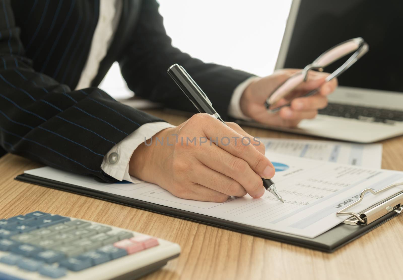Accountants are preparing a report to present to the executive.