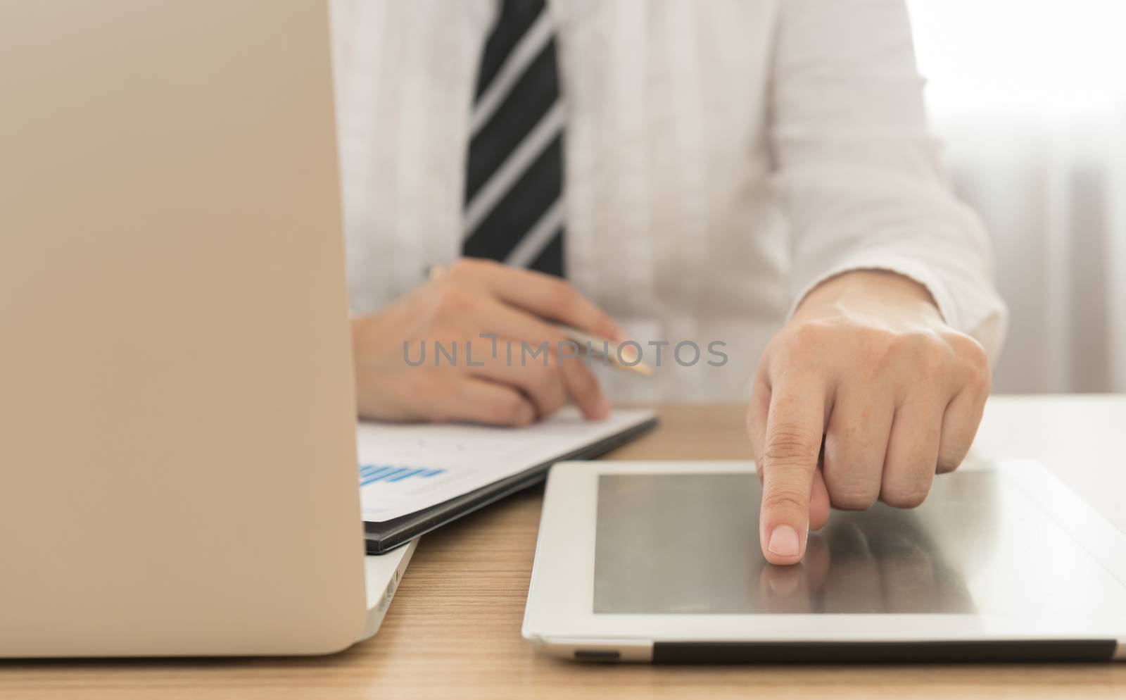 close up businessman's fingers touching the screen tablet computer.