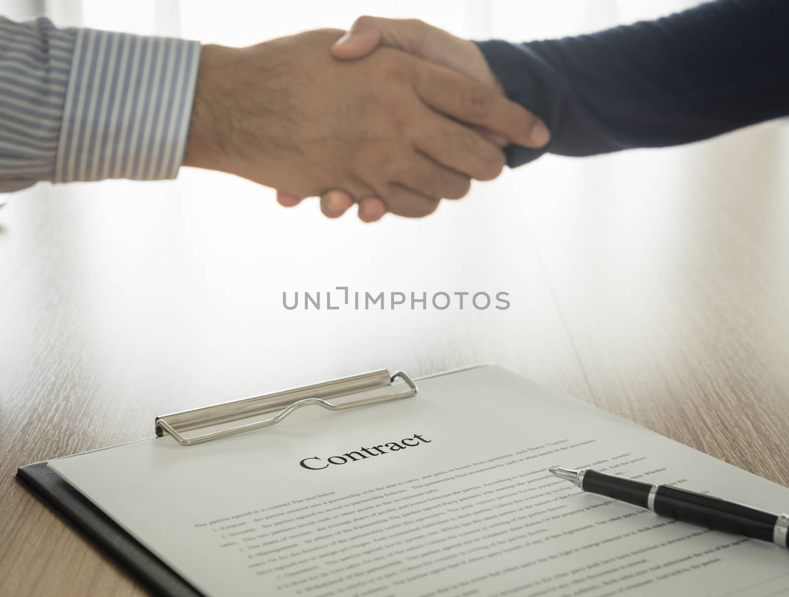 Documents contracting with partners are handshake background. select focus.