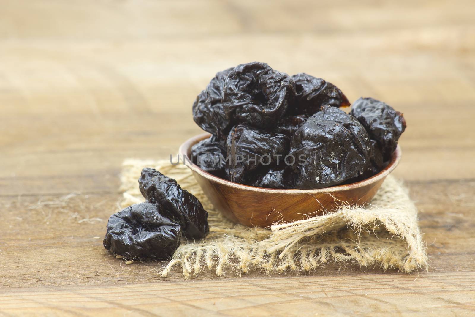 bowl full of dried plums by miradrozdowski