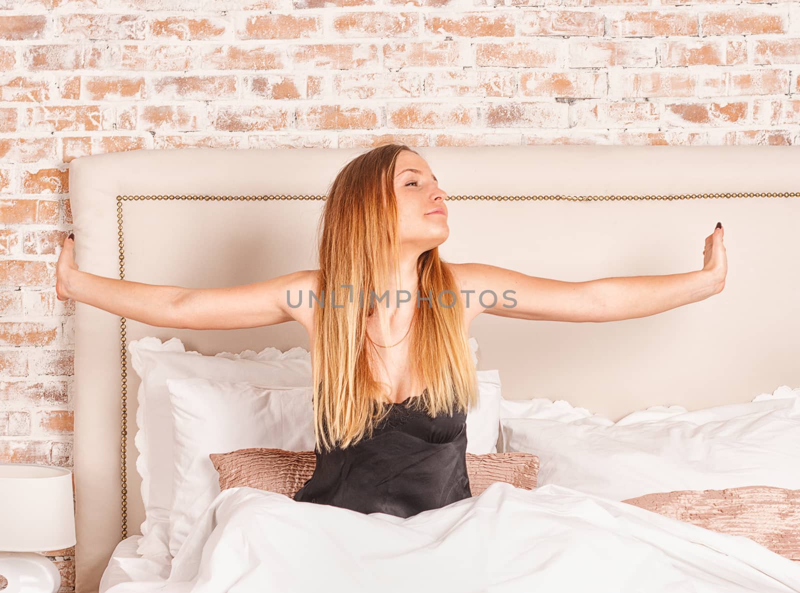 Glowing woman stretching while getting up by victosha