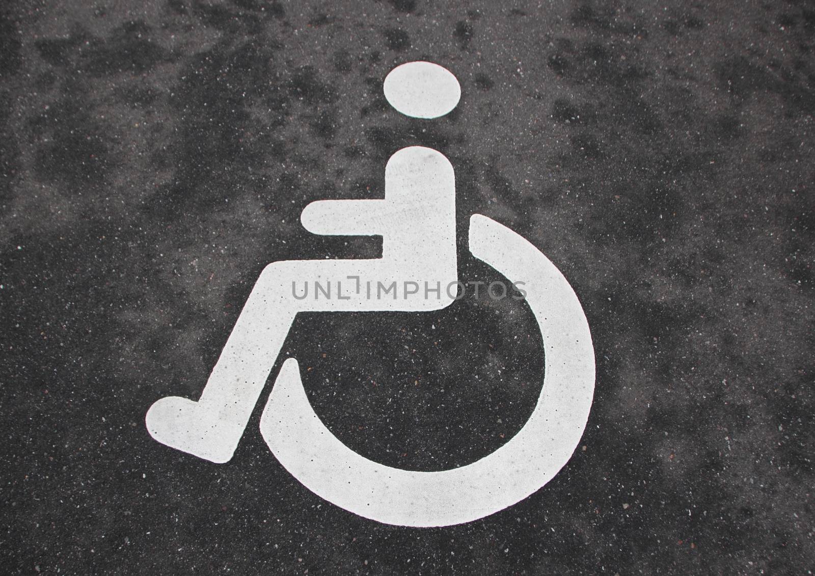 Isolated White Handicap Disabled Sign on Black Asphalt