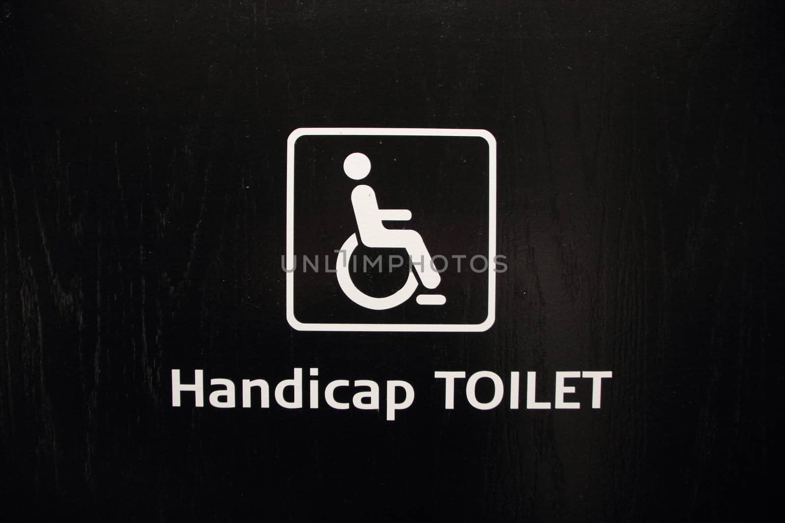 White Handicap Disabled Toilet Sign on Black Wood by HoleInTheBox