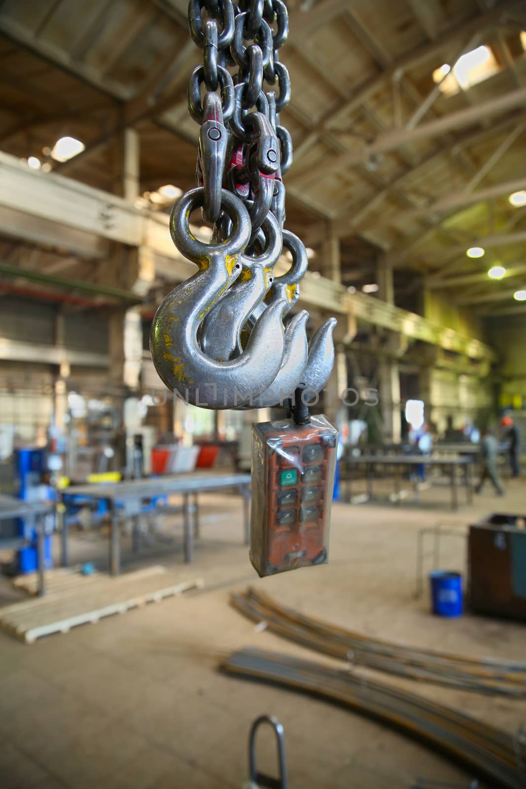 The steel hooks hanging on the background of industrial premises