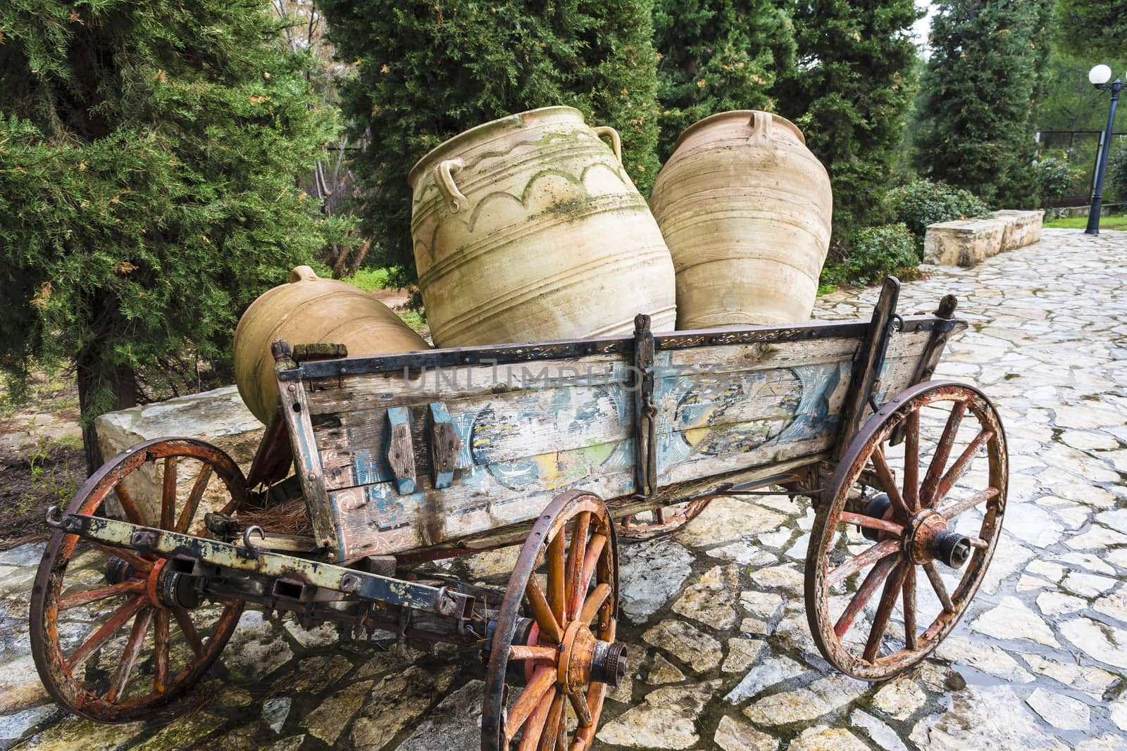 Old horse drawn wooden cart with jars 