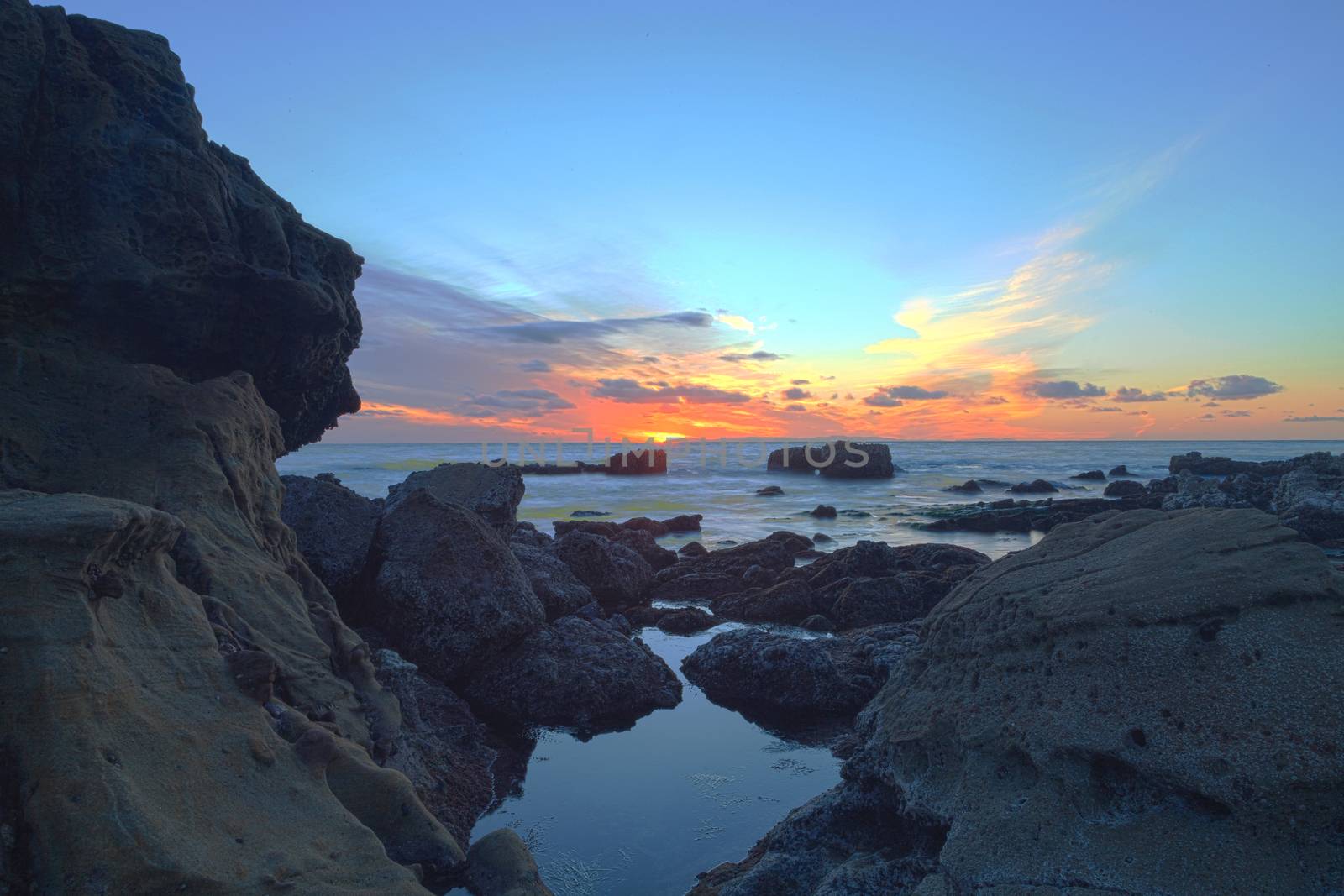 Long exposure of sunset over rocks by steffstarr