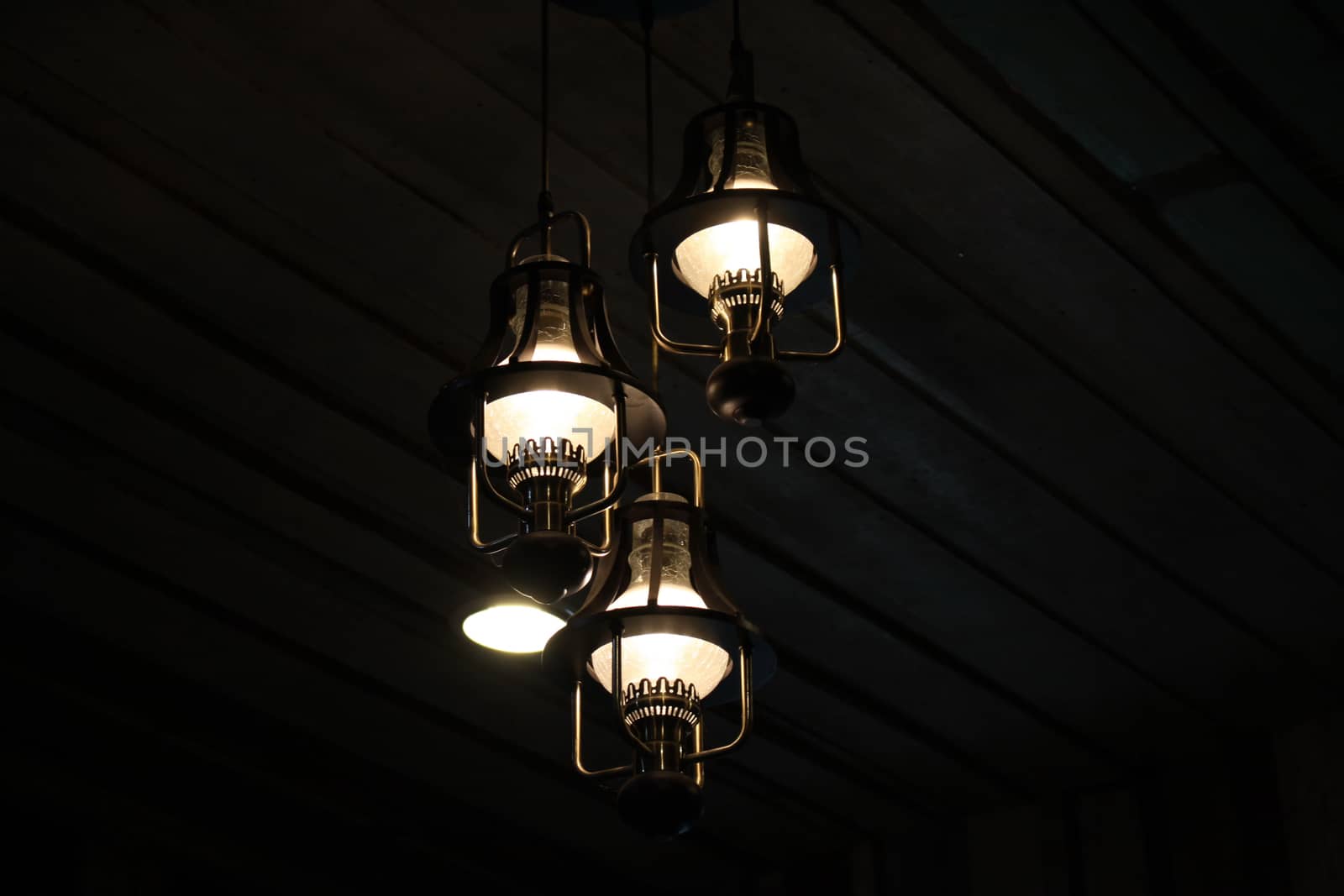 Light bulbs on black wood interiors background in Thai by worrayuth