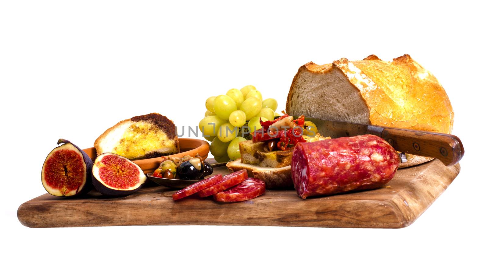 Antipasto catering platter with salami and cheese on a wooden board.