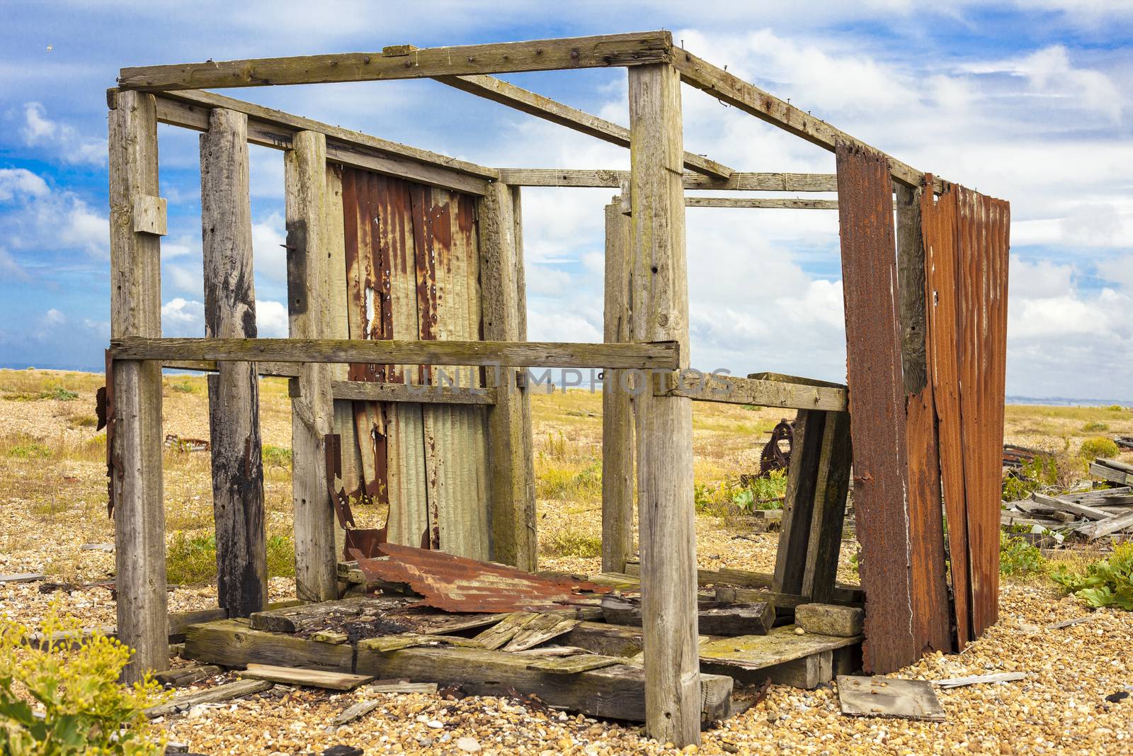 Abandoned fishing hut or old wooden cabin on south coast of England in Dungeness.