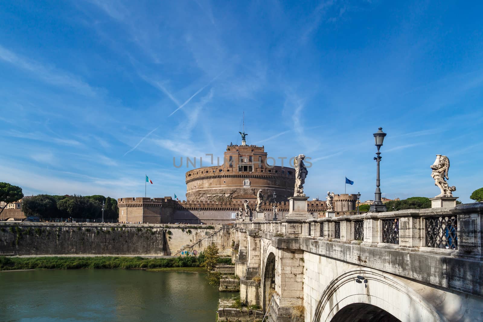 ROME, ITALY - SEPTEMBER 23, 2015 : Vıew of Castel Sant'Angelo, Castle of the Holy Angel built by Hadrian in Rome, along Tiber River on bright blue sky background.
