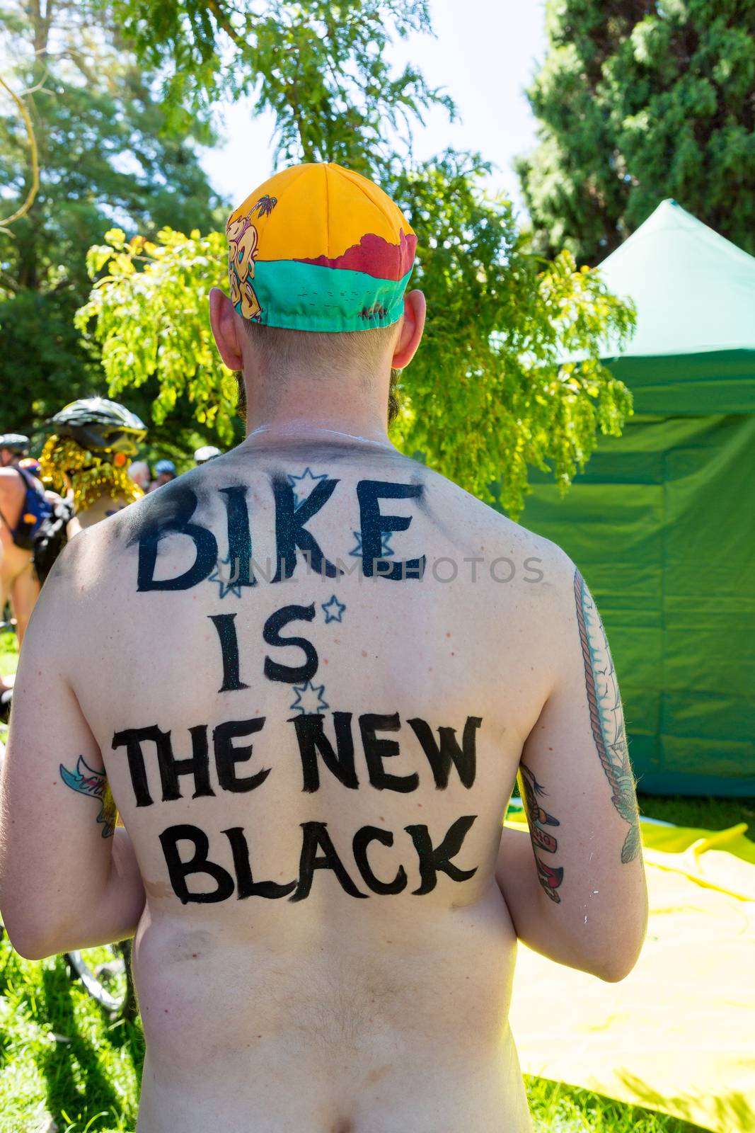 AUSTRALIA, Melbourne: A man with 'Bike is the new black' written on his back takes part in the World Naked Bike Ride (WNBR) on the streets of Melbourne on February 28, 2016.About 200 naked cyclists rode in the event called 'As bare as they dare'. The event aimed at raising awareness around cyclists' safety. 