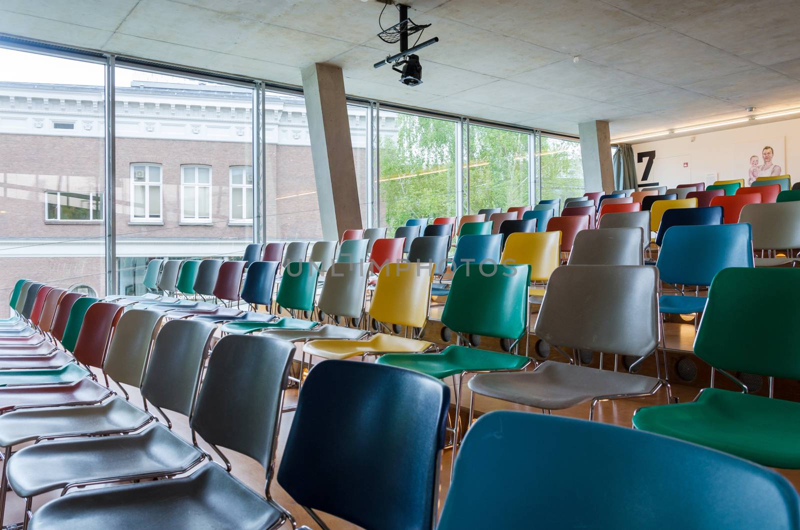 Colorful chairs in auditorium by siraanamwong