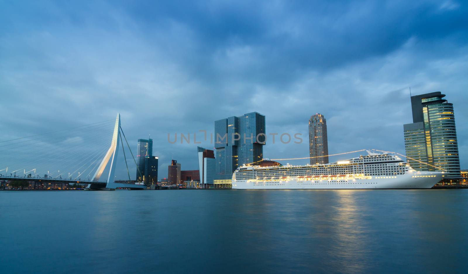 Twilight at Erasmus Bridge with Skyscraper in Rotterdam by siraanamwong