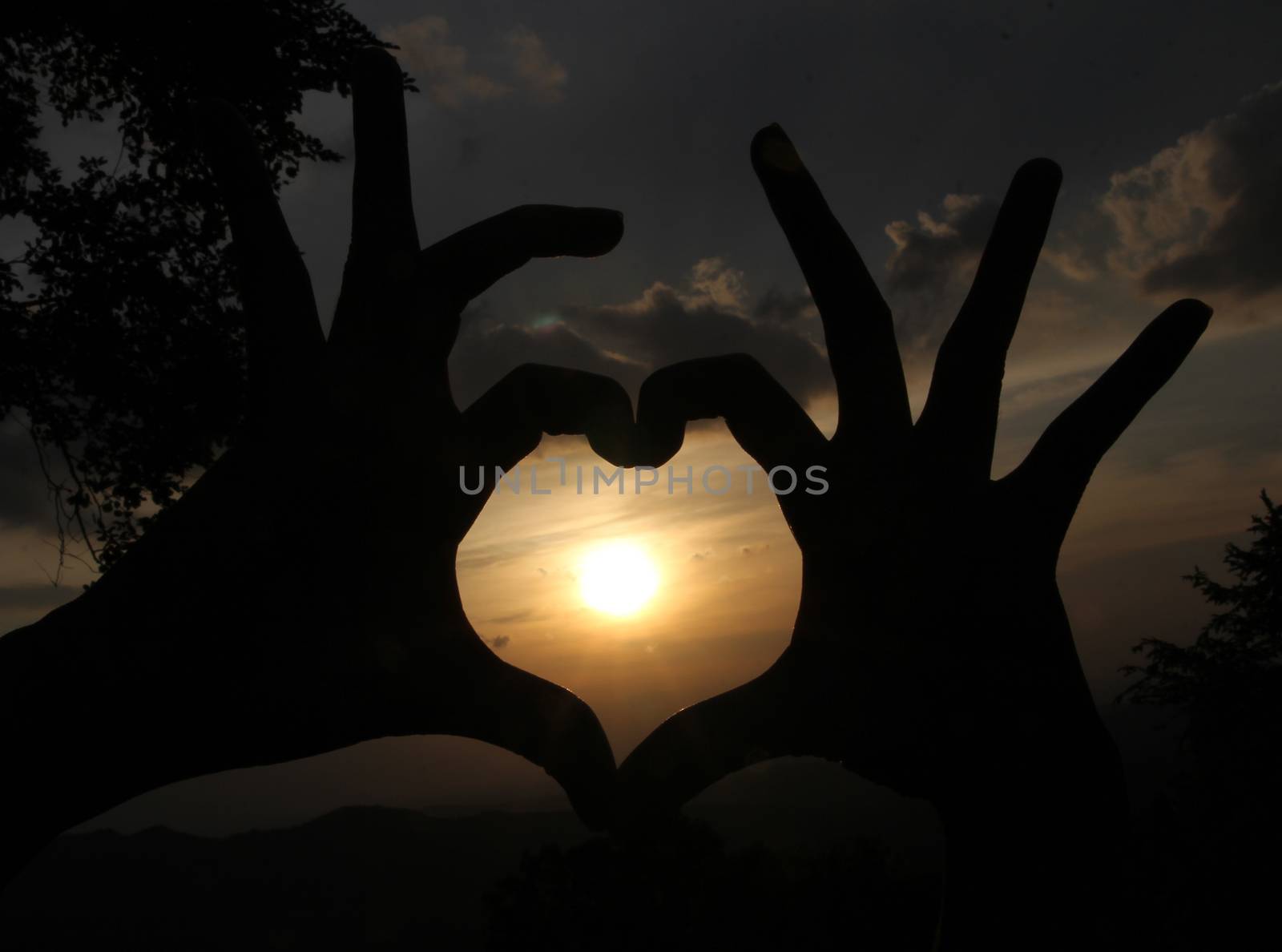 love heart from hands before sunset  at viewpoimt on mountain