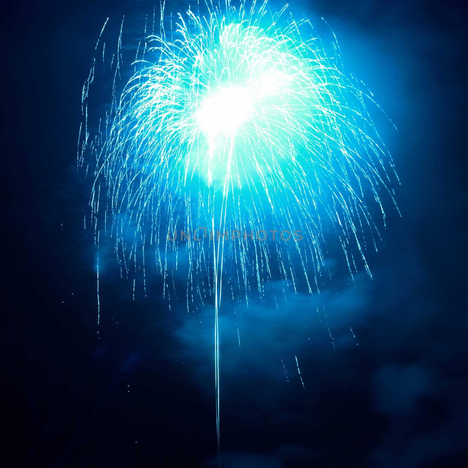 Blue fireworks on the black sky background