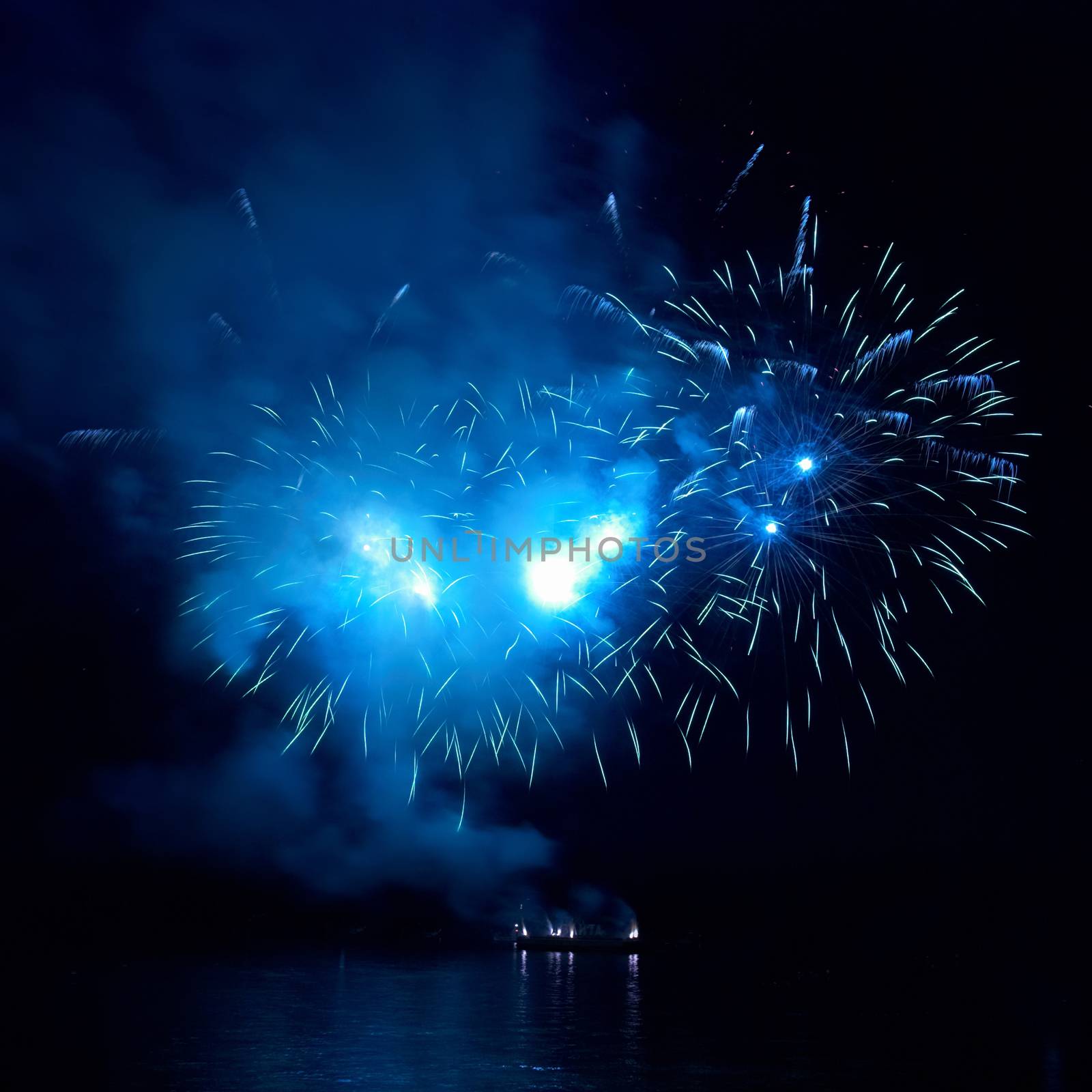 Blue fireworks on the black sky background