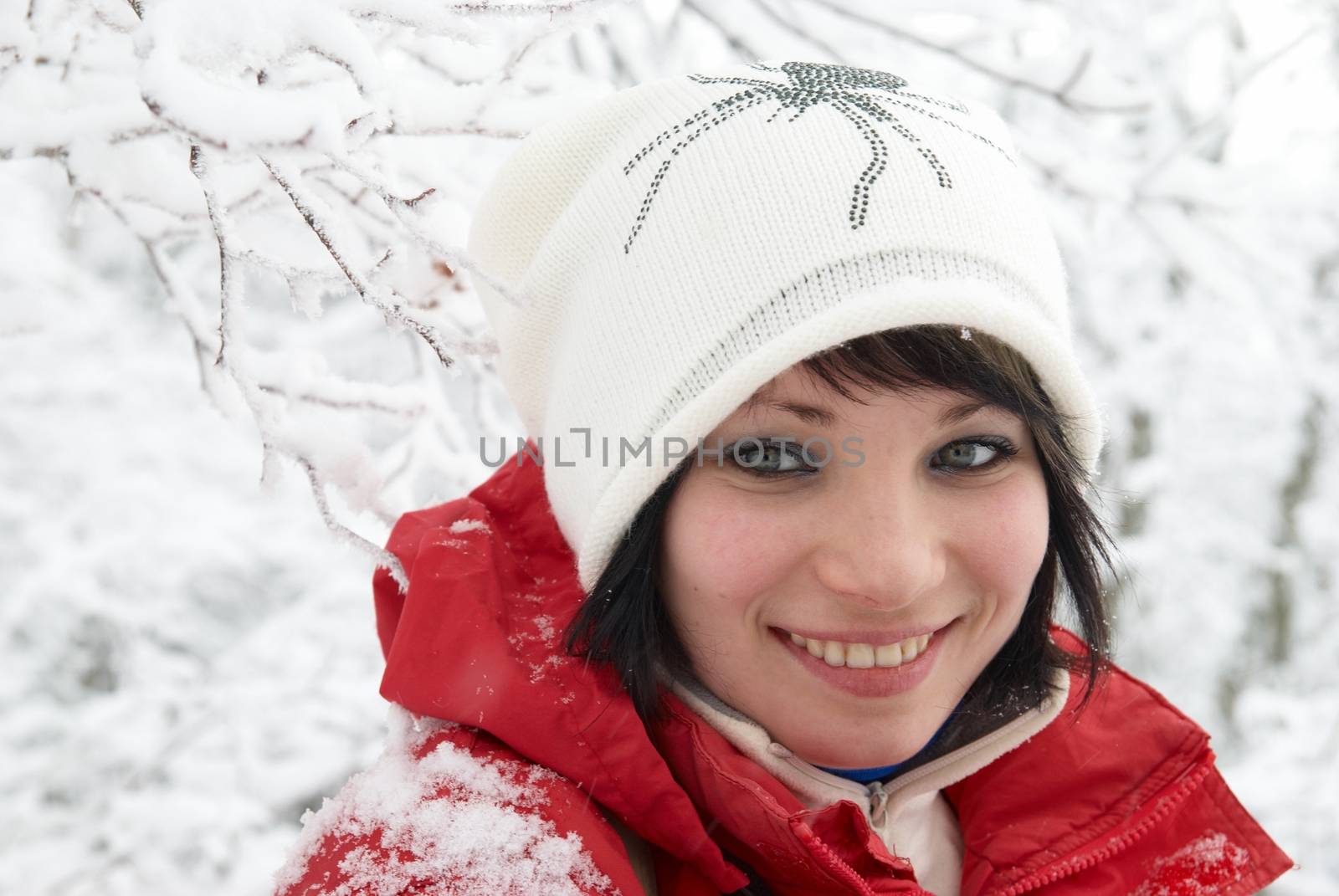 Pretty winter girl in the snow forest