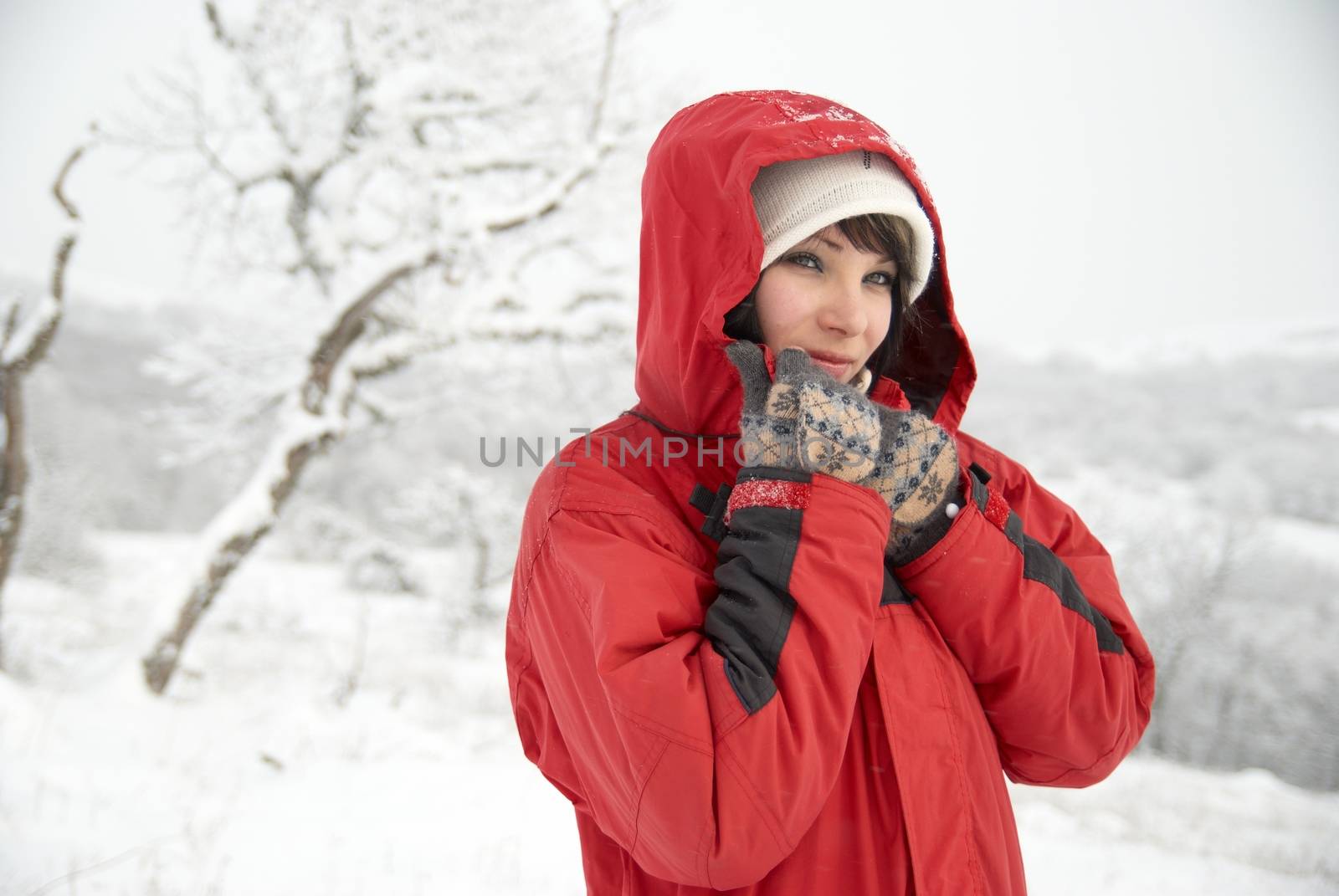 Pretty winter girl in the snow forest