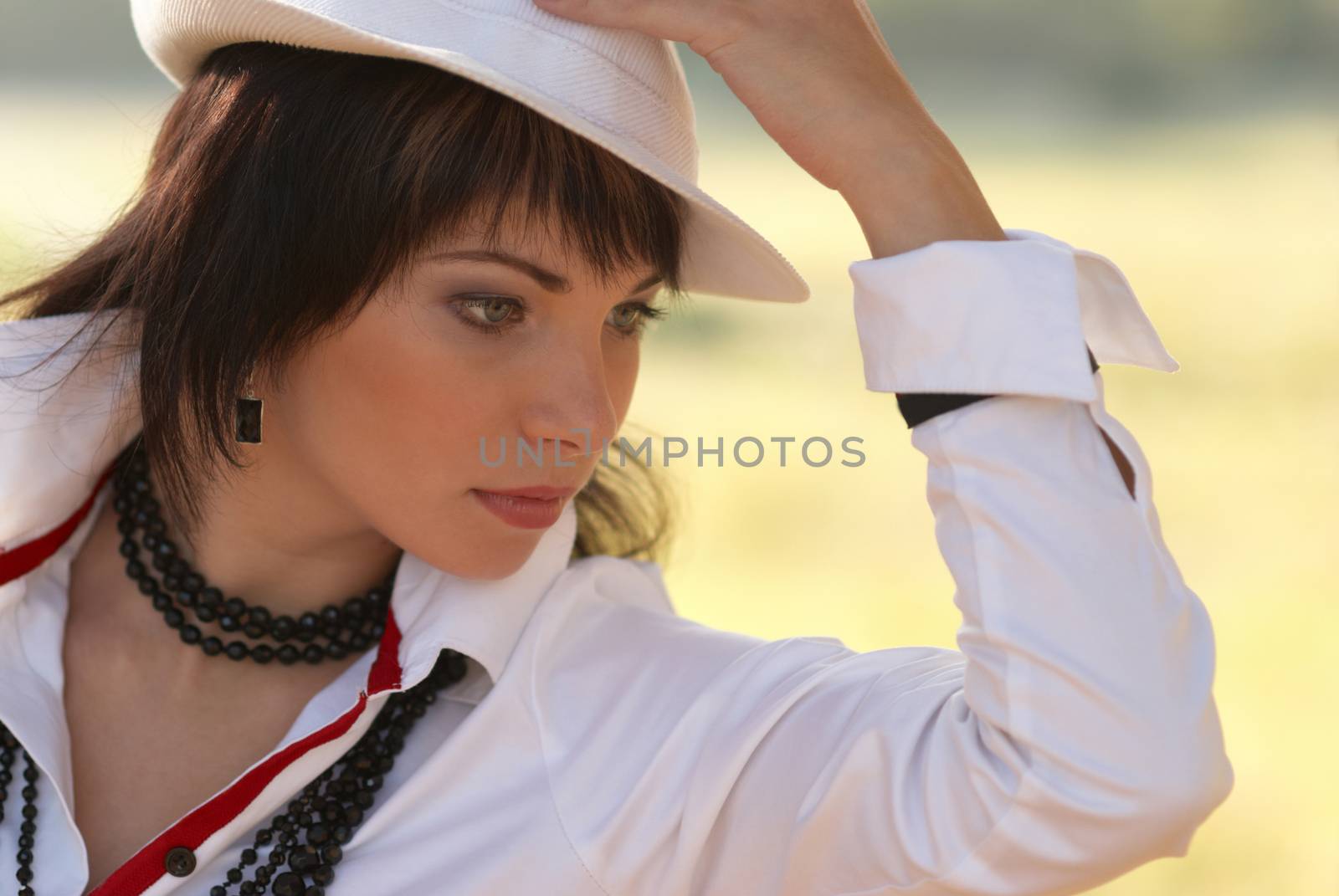 Beautiful girl in the white hat- soft background portrait