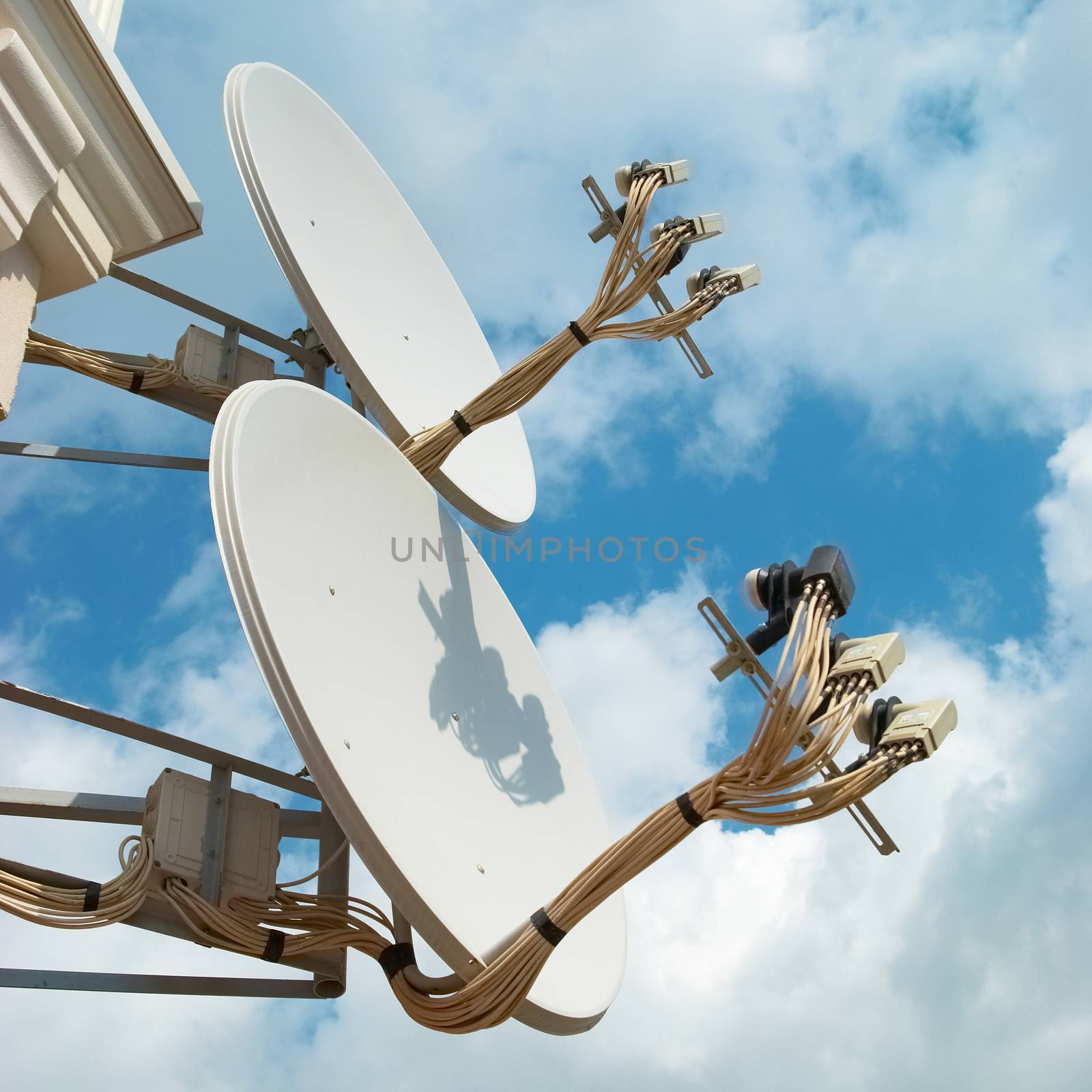 Satellite antenna on the wall with blue sky