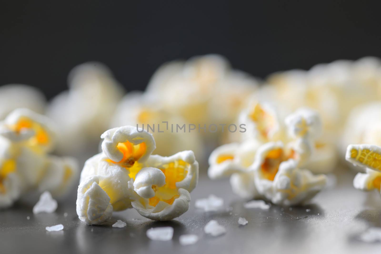 Popcorn and salt isolated on black background