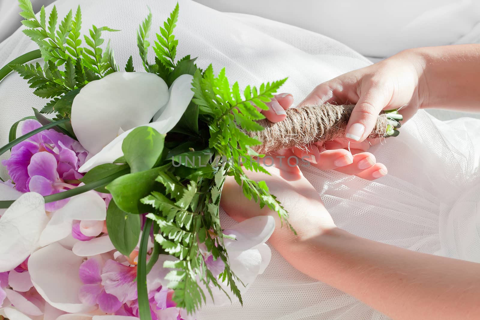 fragment like view of girl holding flowers on white