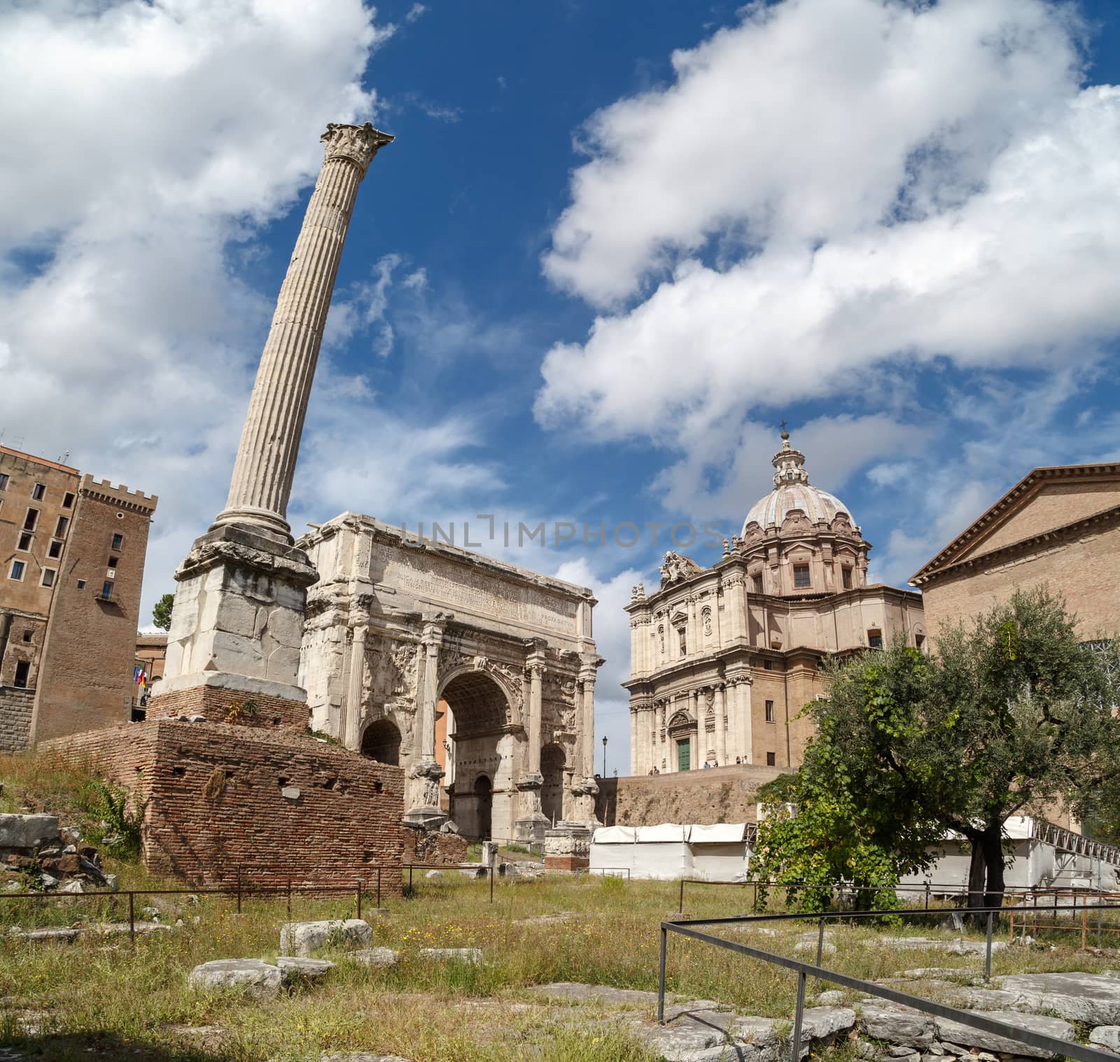 ROME, ITALY - SEPTEMBER 24, 2015 : View of ancient Roman Forum in Rome, on cloudy blue sky background.