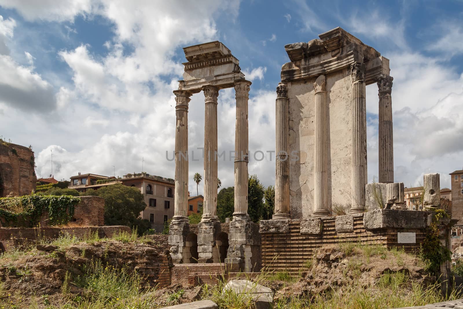 View of archeological area of ancient Roman Forum in Rome, on cloudy blue sky background.