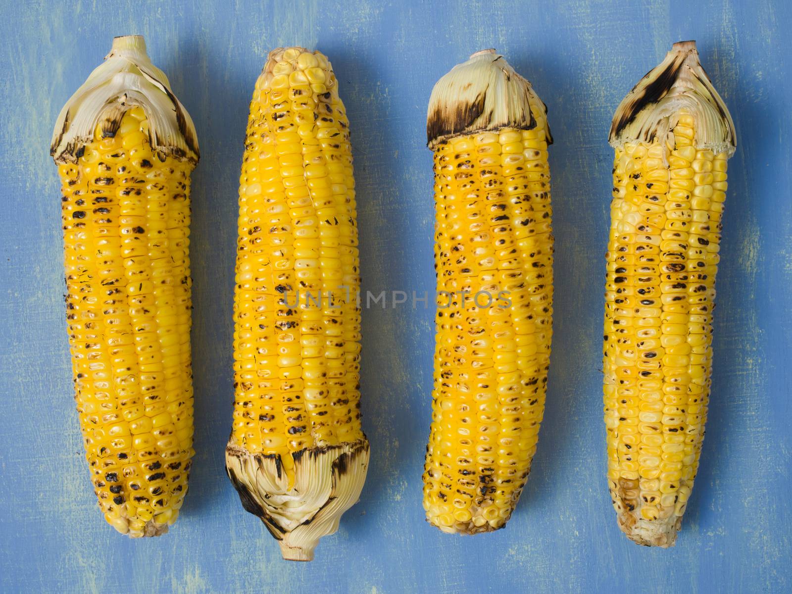 close up of rustic grilled golden corn cob