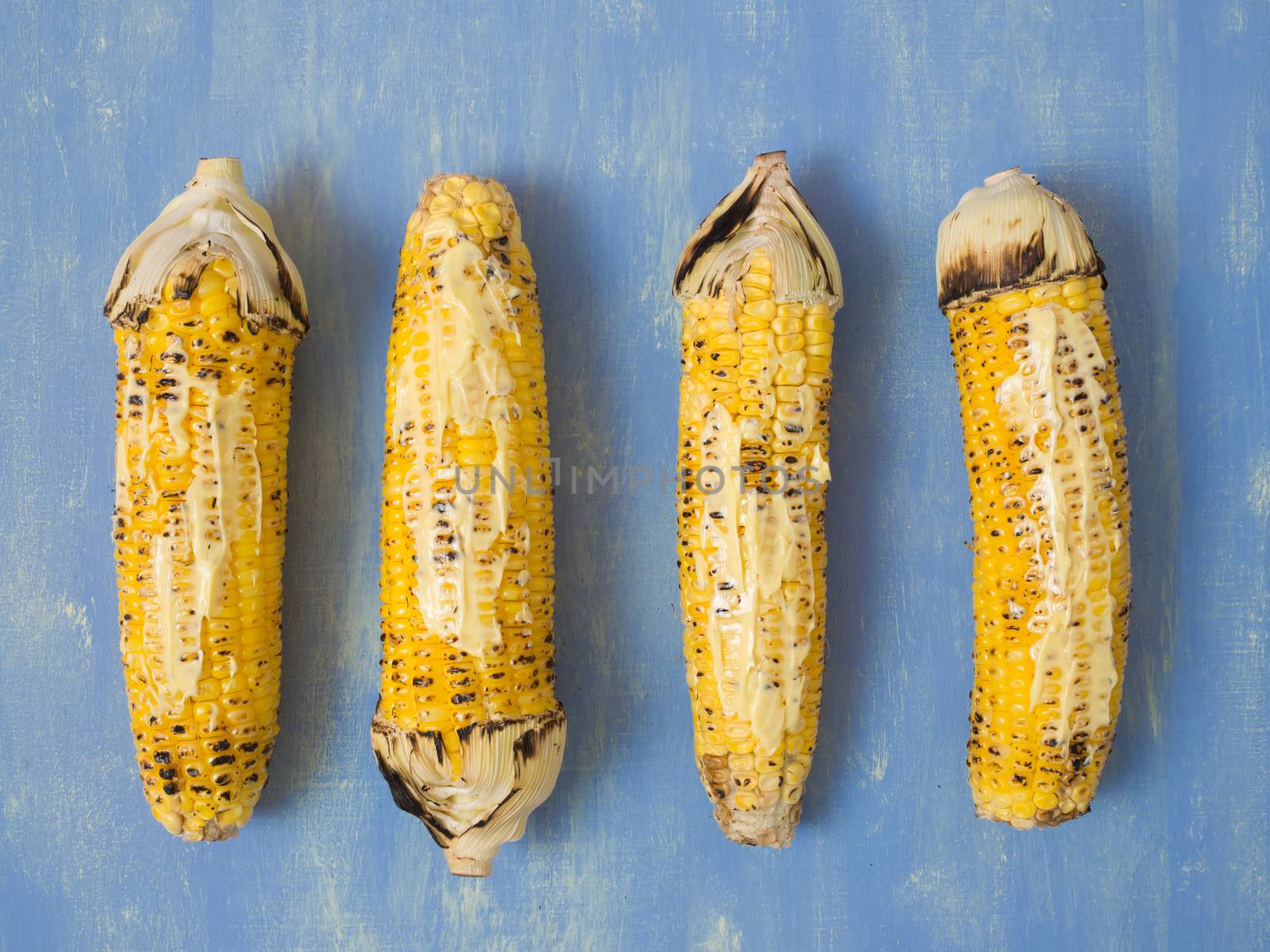 close up of rustic grilled golden corn cob