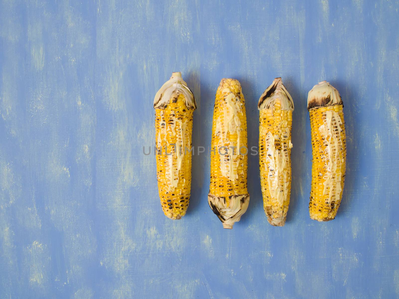 close up of rustic grilled golden corn cob