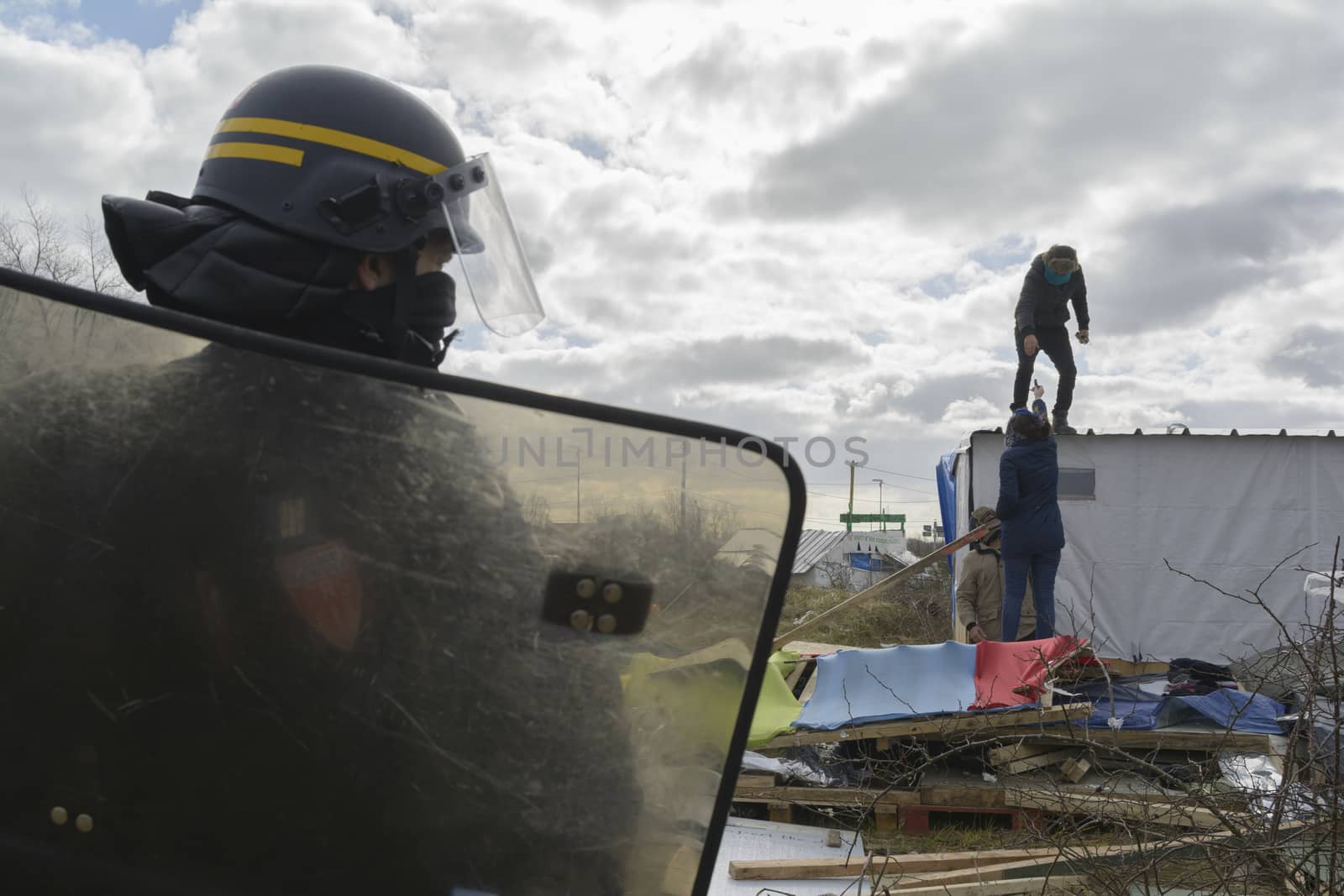 FRANCE, Calais: Policemen stand next to shelters on February 29, 2016 in the jungle migrants and refugees camp in Calais, northern France as agents dismantle the southern half of the sprawling camp in the port town.
A French court on February 25 gave the green light to plans to evacuate hundreds of migrants, with many wanting to stay near the entrance to the Channel Tunnel, the gateway to their ultimate goal of Britain. 